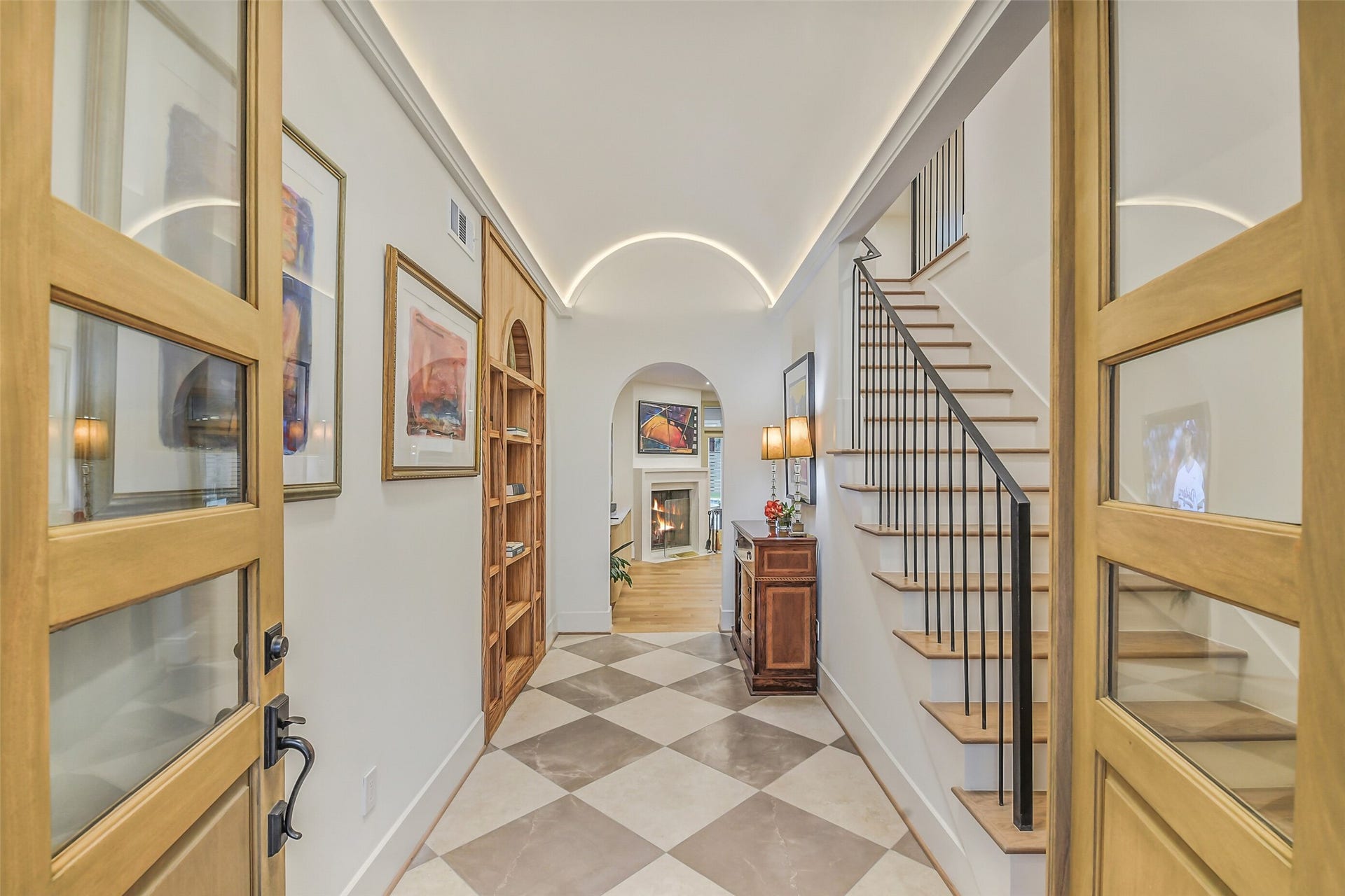 9411 Millbury Drive, Houston, TX 77096 Step through elegant double doors into a stunning foyer featuring cove lit barrel ceilings, a dramatic staircase, and beautiful stone tile flooring.