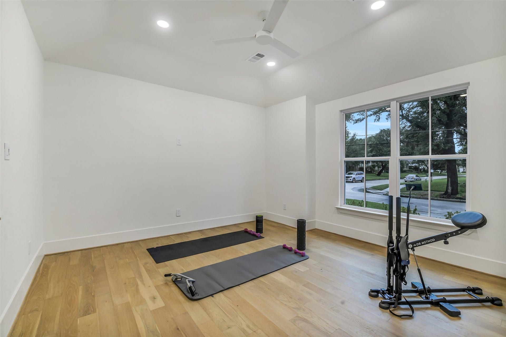 9411 Millbury Drive, Houston, TX 77096 A bright, versatile room with vaulted ceilings, a ceiling fan, and a large window overlooking the front yard. Currently set up as a home gym, this flexible space easily adapts to a playroom, office, or additional living area to suit your needs.