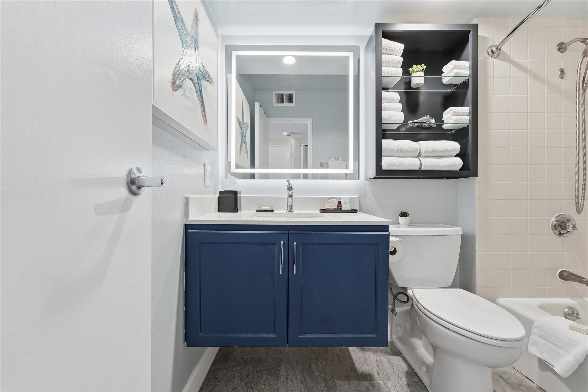 5220 Seawall Boulevard, #1038D, Galveston, TX 77551 Open shelving provides handy bathroom storage, while coordinating finishes carry the coastal style throughout.