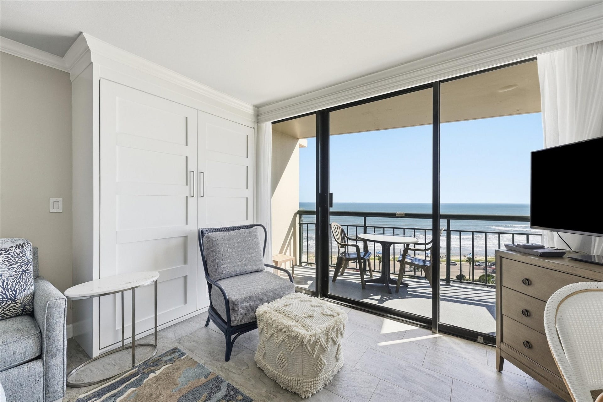 5220 Seawall Boulevard, #1038D, Galveston, TX 77551 Sliding glass doors welcome abundant sunshine and provide direct access to the covered balcony.