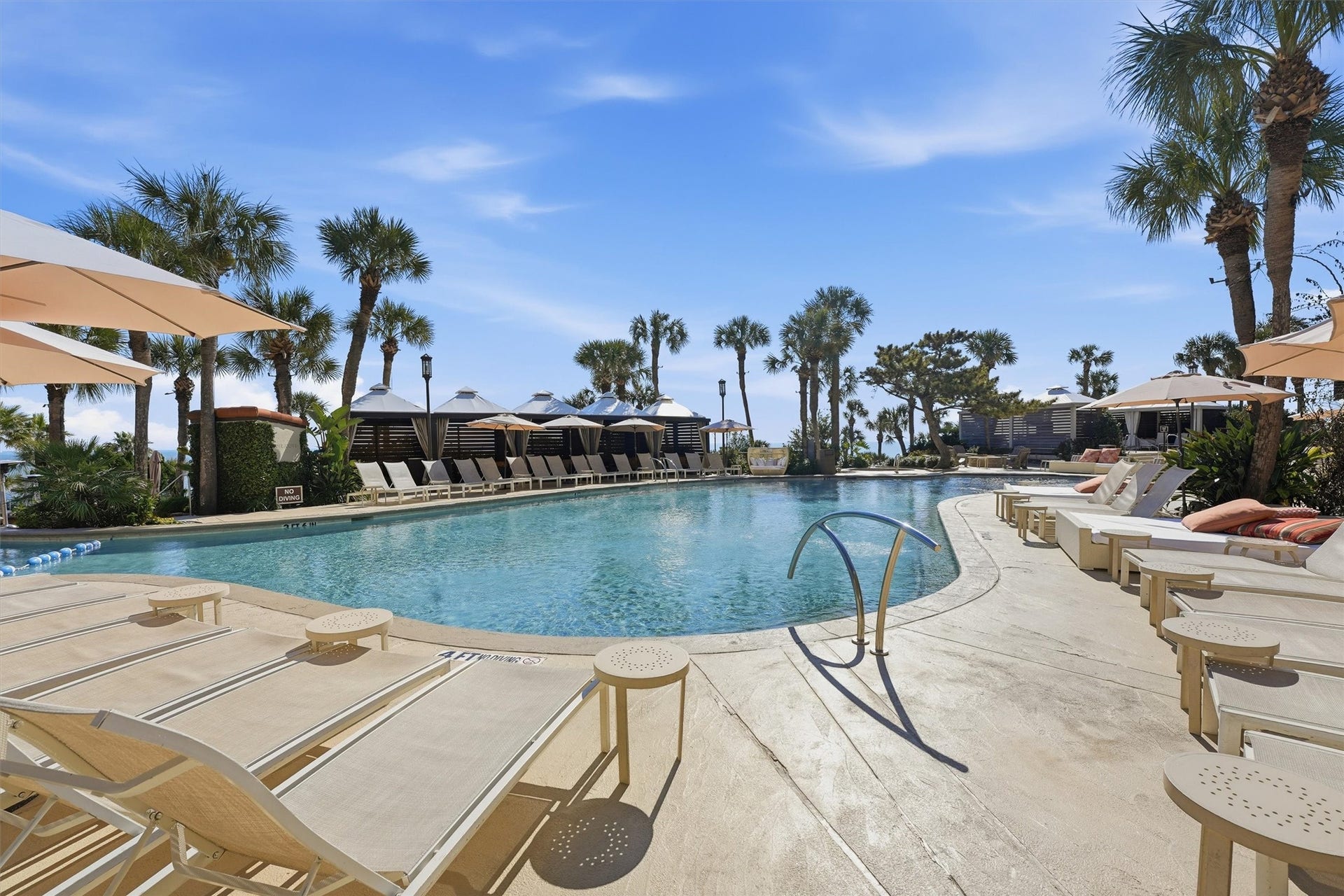 5220 Seawall Boulevard, #1038D, Galveston, TX 77551 A resort-style pool area offers an inviting place to unwind, soak up the coastal atmosphere, and enjoy beautifully maintained grounds just steps from the beach.