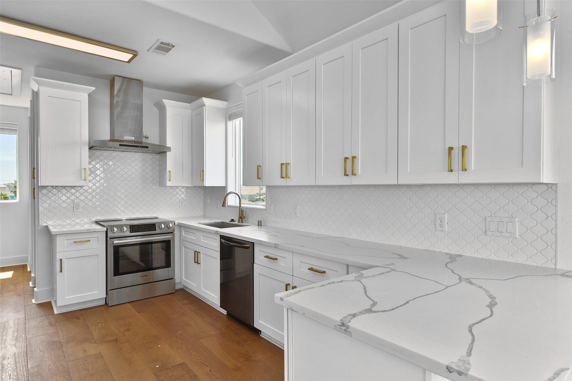 4006 Fort Bend Drive, Galveston, TX 77554 Quartz countertops, and a stunning tile backsplash a show stoppers .