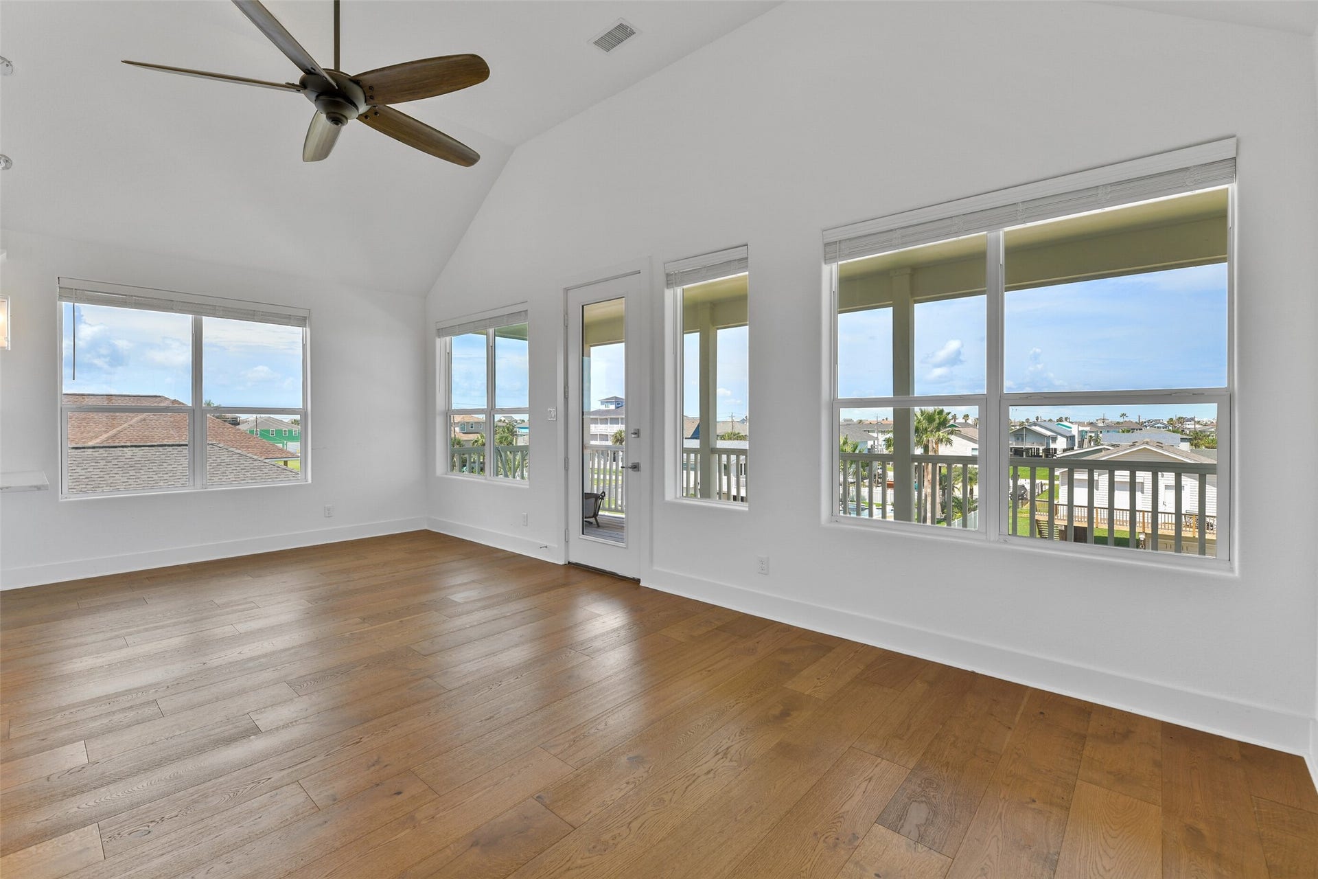 4006 Fort Bend Drive, Galveston, TX 77554 The living area is open to both the kitchen and dining area, and is surrounded with natural light through the many windows.