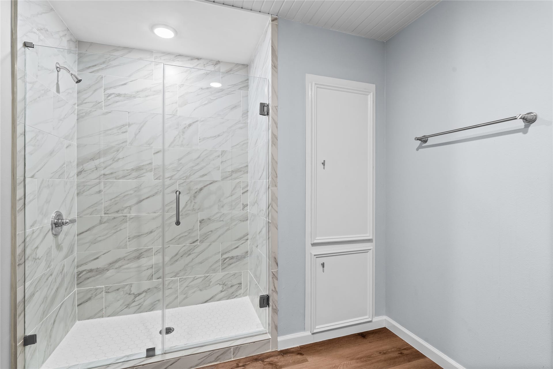 645 3rd Street, San Leon, TX 77539 A generous walk-in shower with a frameless glass enclosure is complemented by built-in linen storage, adding convenience without sacrificing space.