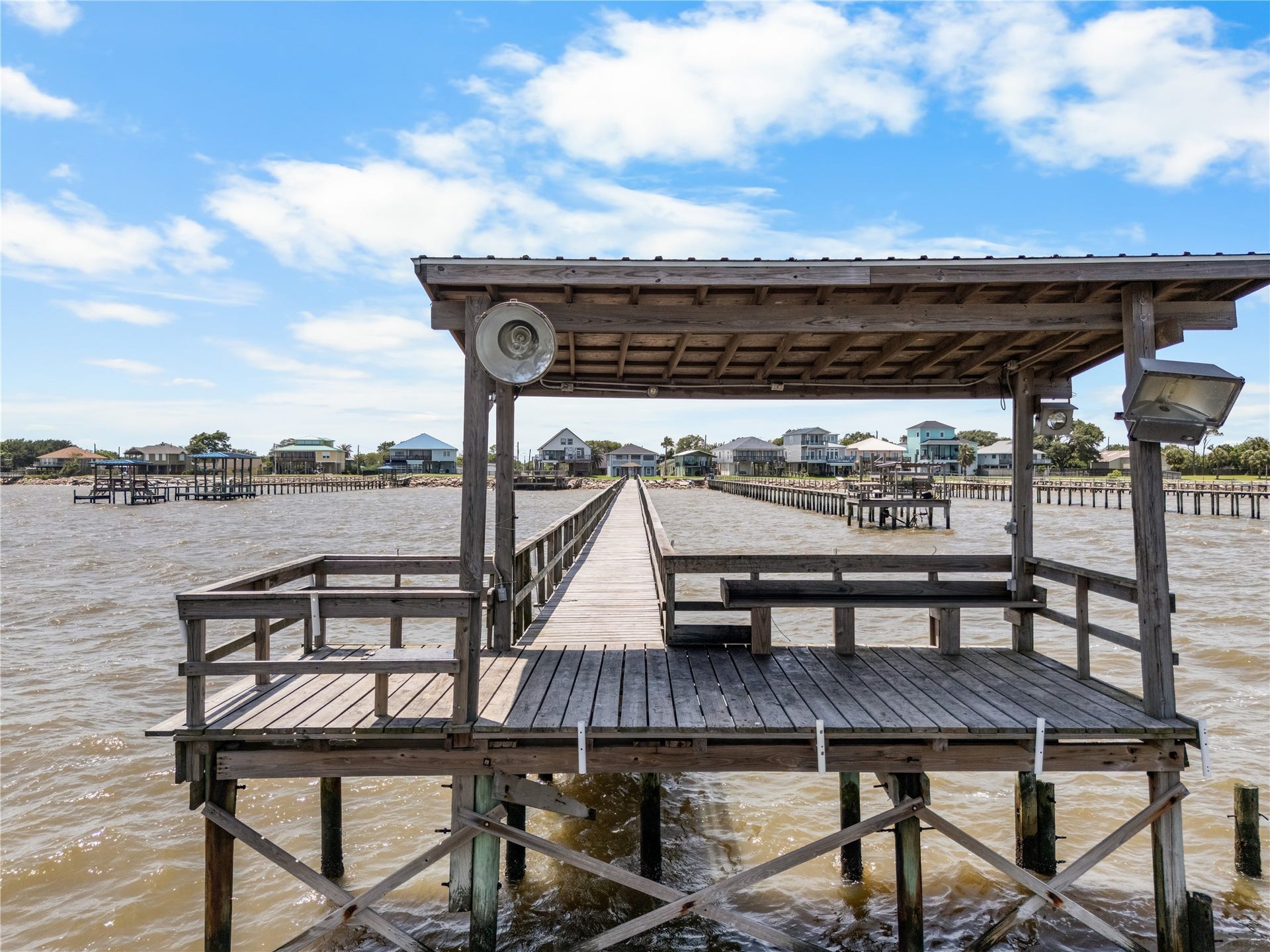 645 3rd Street, San Leon, TX 77539 The best seat on the bay is waiting. Whether you're reeling in the day's catch or unwinding beneath the shade, this covered dock was made for slow coastal afternoons.