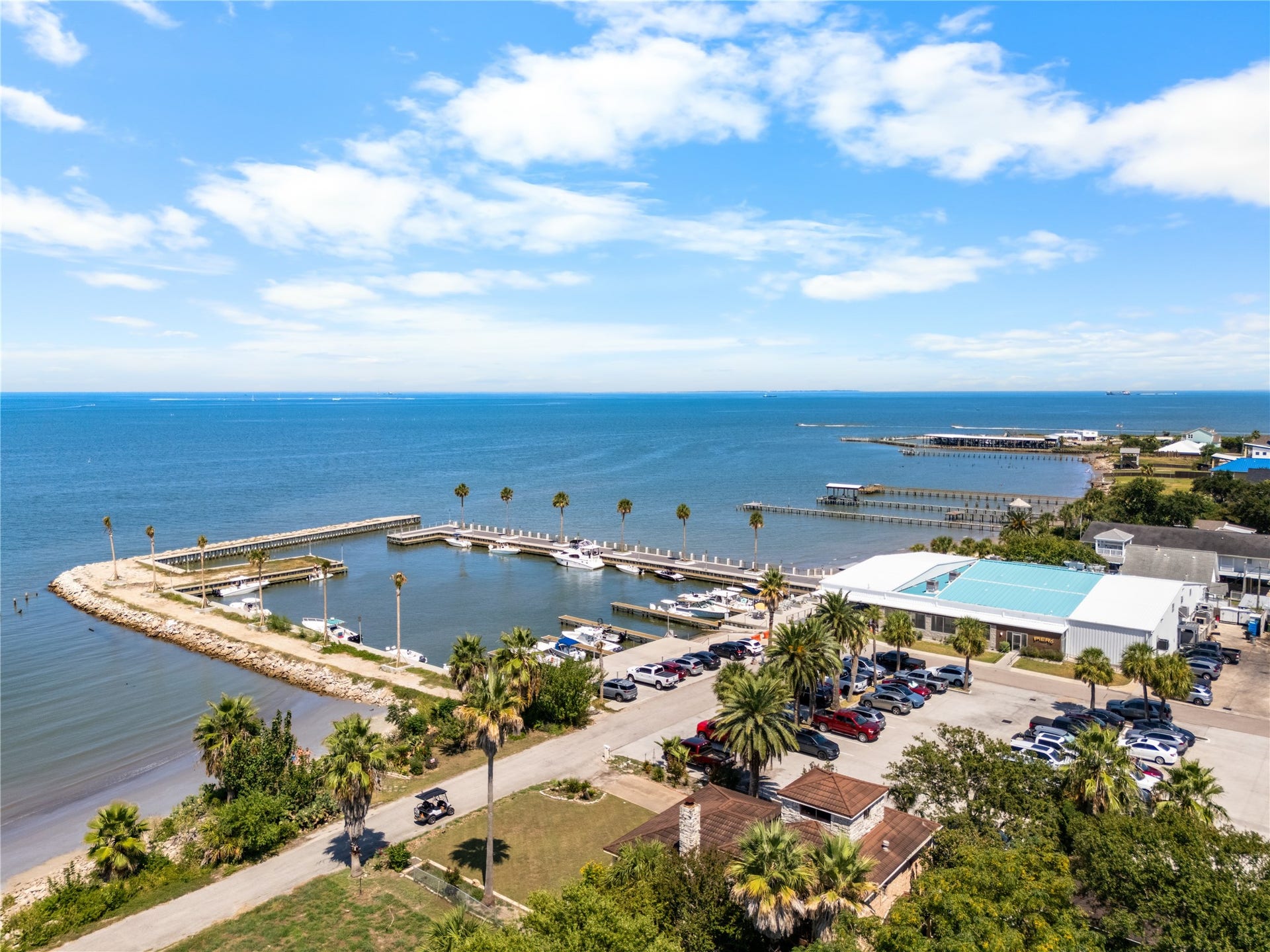 645 3rd Street, San Leon, TX 77539 Floor-to-ceiling cabinetry, quartz countertops, and a coastal-inspired palette create a kitchen that feels both functional and inviting, with the bay as its backdrop.