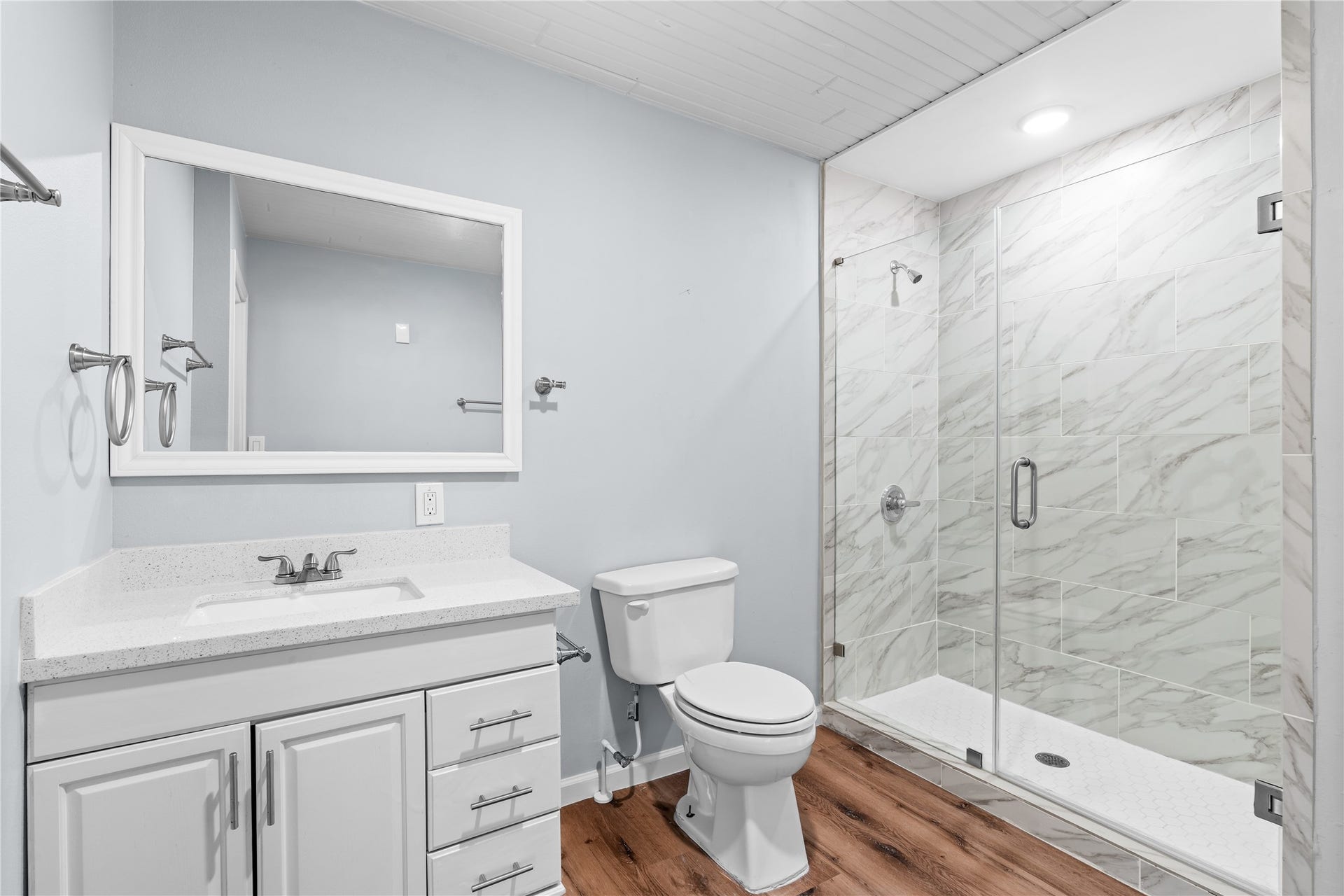 645 3rd Street, San Leon, TX 77539 A generous walk-in shower with a frameless glass enclosure is complemented by built-in linen storage, adding convenience without sacrificing space.