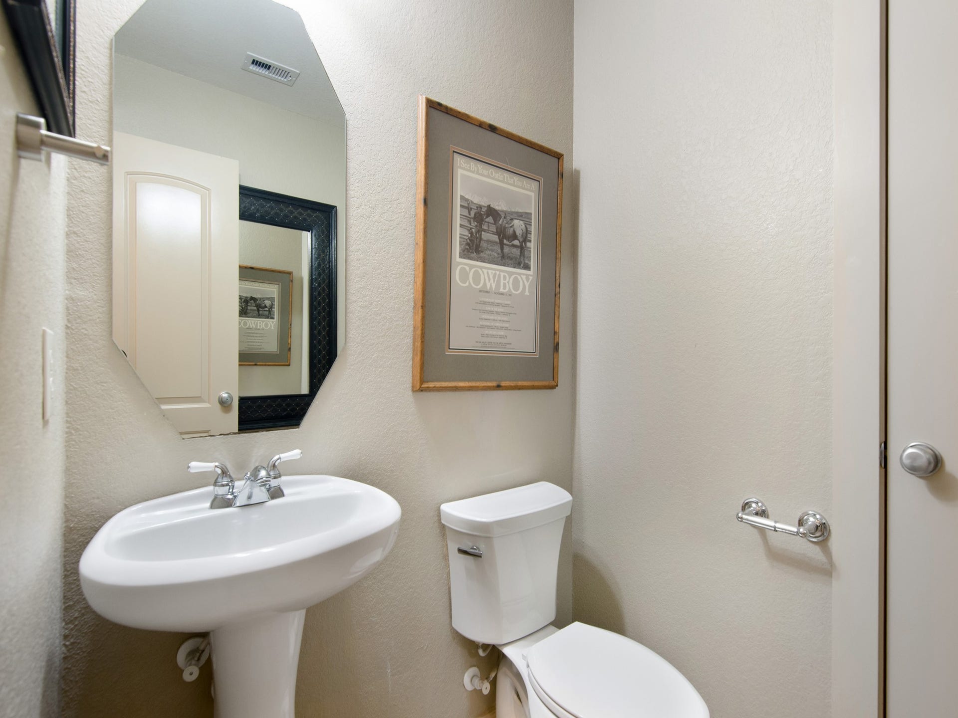 A conveniently located guest bath and nearby storage closet add everyday functionality to the main level.