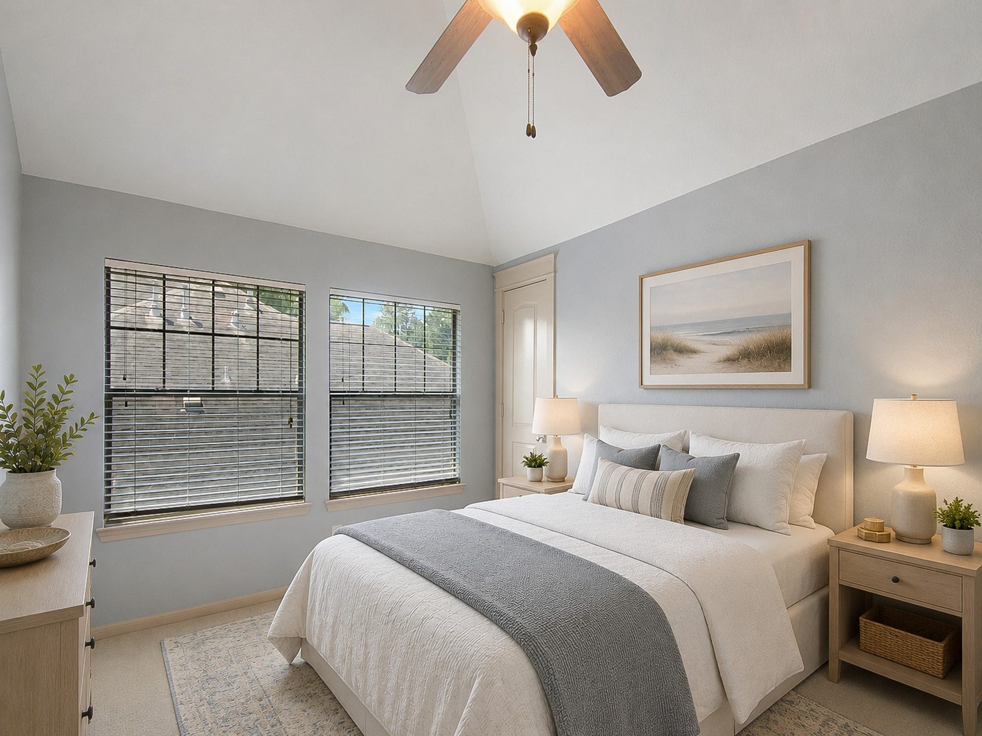virtually staged bedroom features vaulted ceiling and generous closet space.