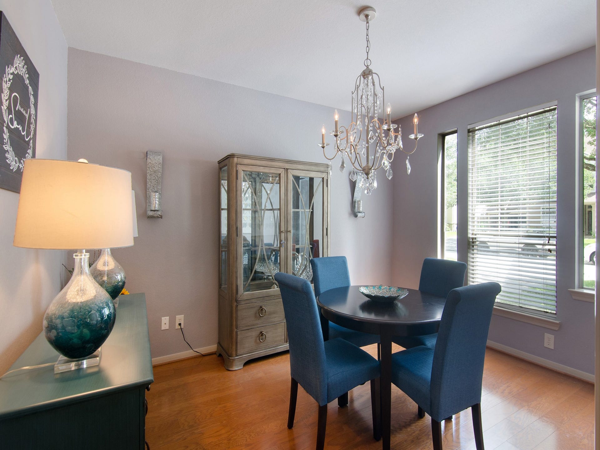 The formal dining room combines elegance and warmth with rich wood flooring, an eye-catching chandelier and large windows that fill the space with natural light, creating the perfect setting for holiday gatherings and special occasions.