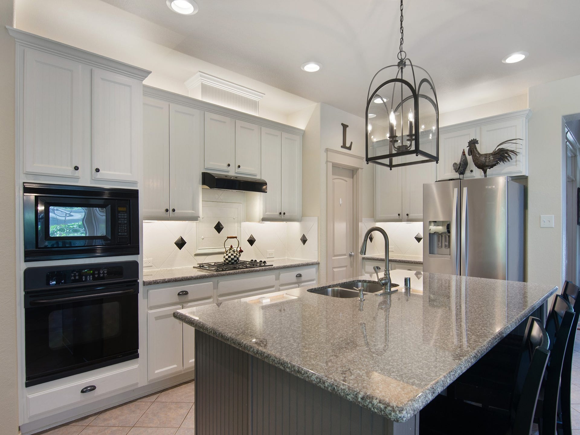 The heart of the home, this beautifully designed transitional kitchen features a large center island with seating, granite countertops, abundant cabinetry and ambient above-and-below cabinet lighting. It offers the perfect blend of beauty, function and everyday comfort.