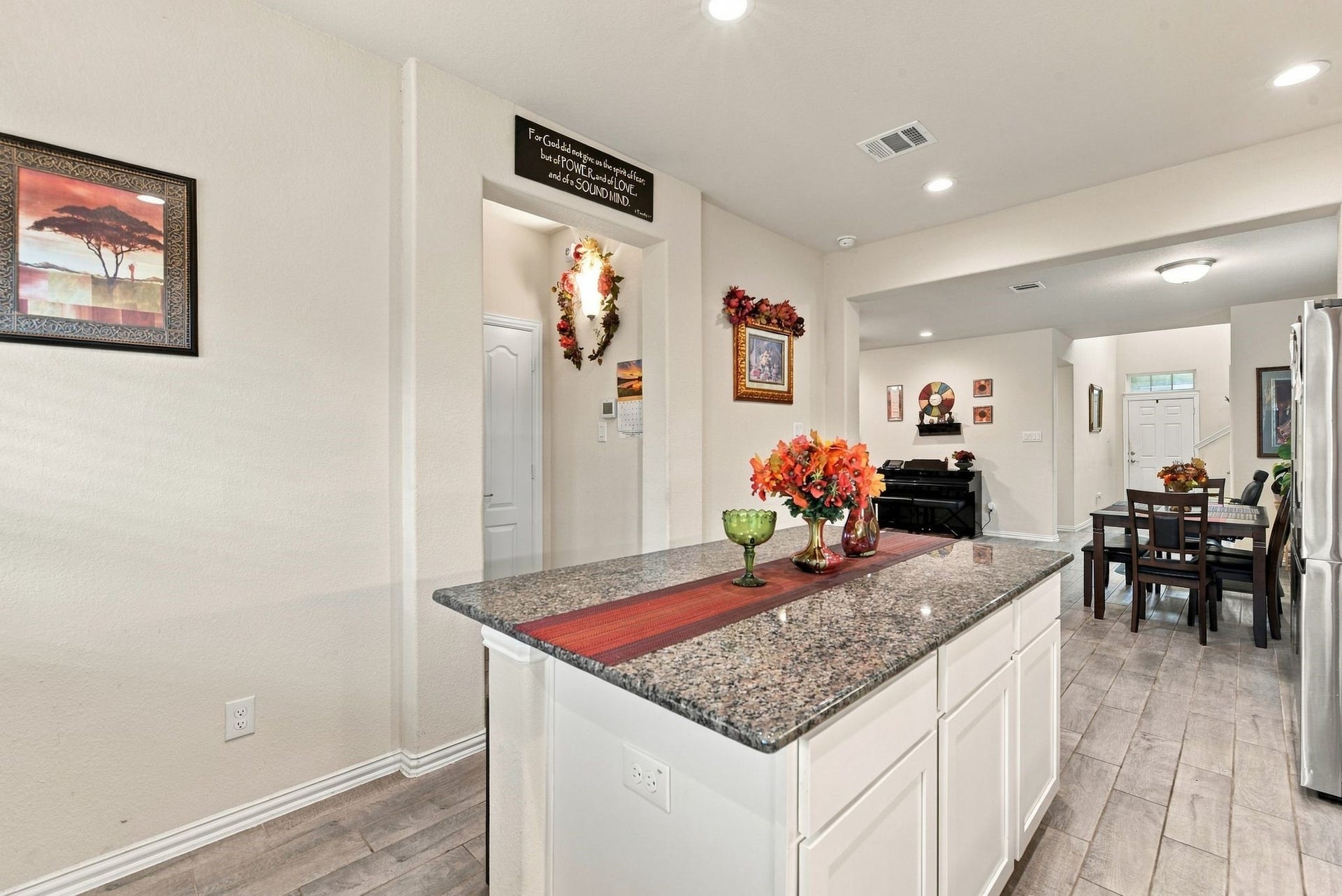 13202 Dancing Reed Drive, Texas City, TX 77568 Sleek granite island, seamlessly flowing into an open-concept dining and living area, perfect for entertaining.