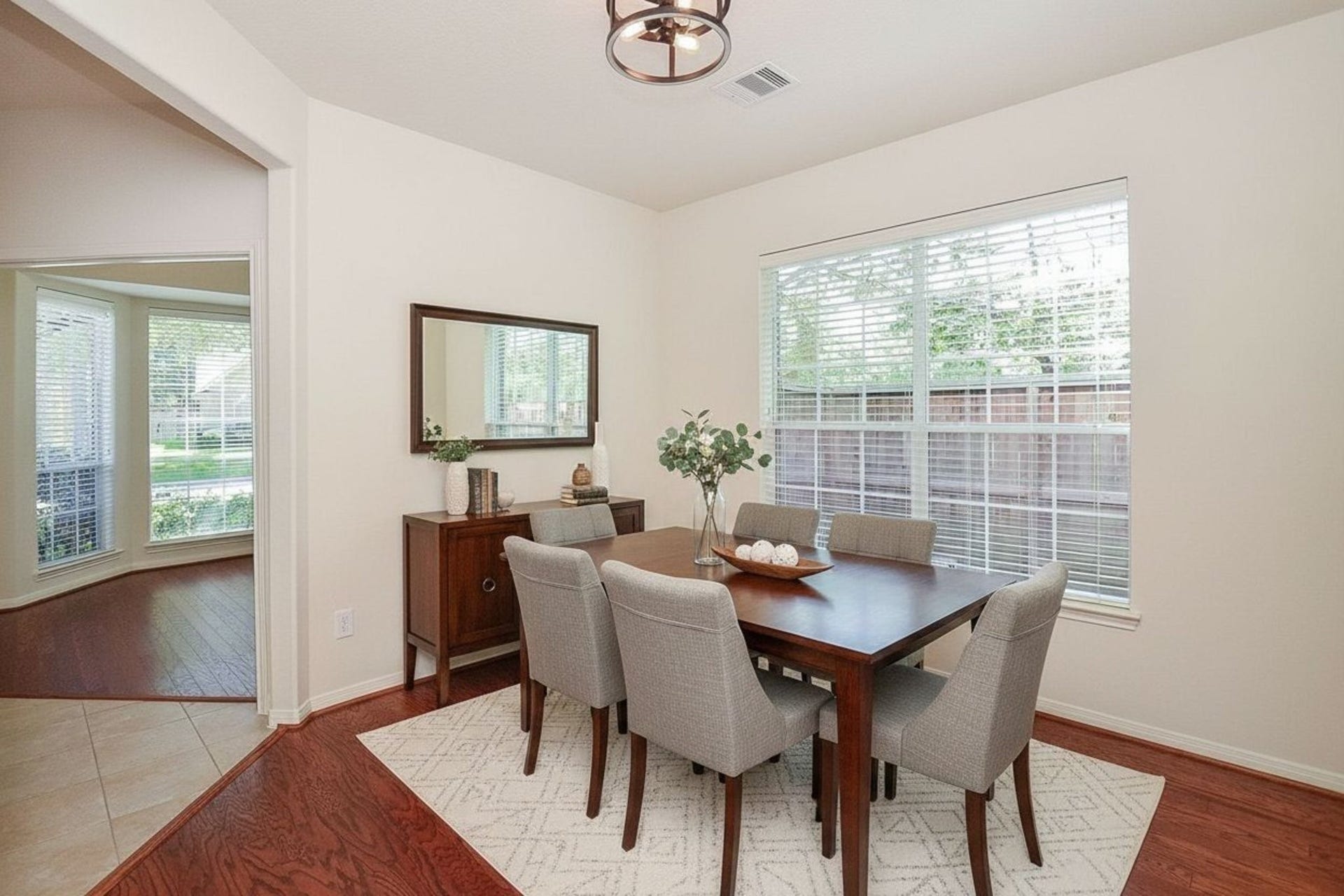 4746 Autumn Orchard Lane, Katy, TX 77494 Bright and inviting, this virtually staged dining room offers an abundance of natural light through large windows, creating the perfect setting for memorable gatherings.