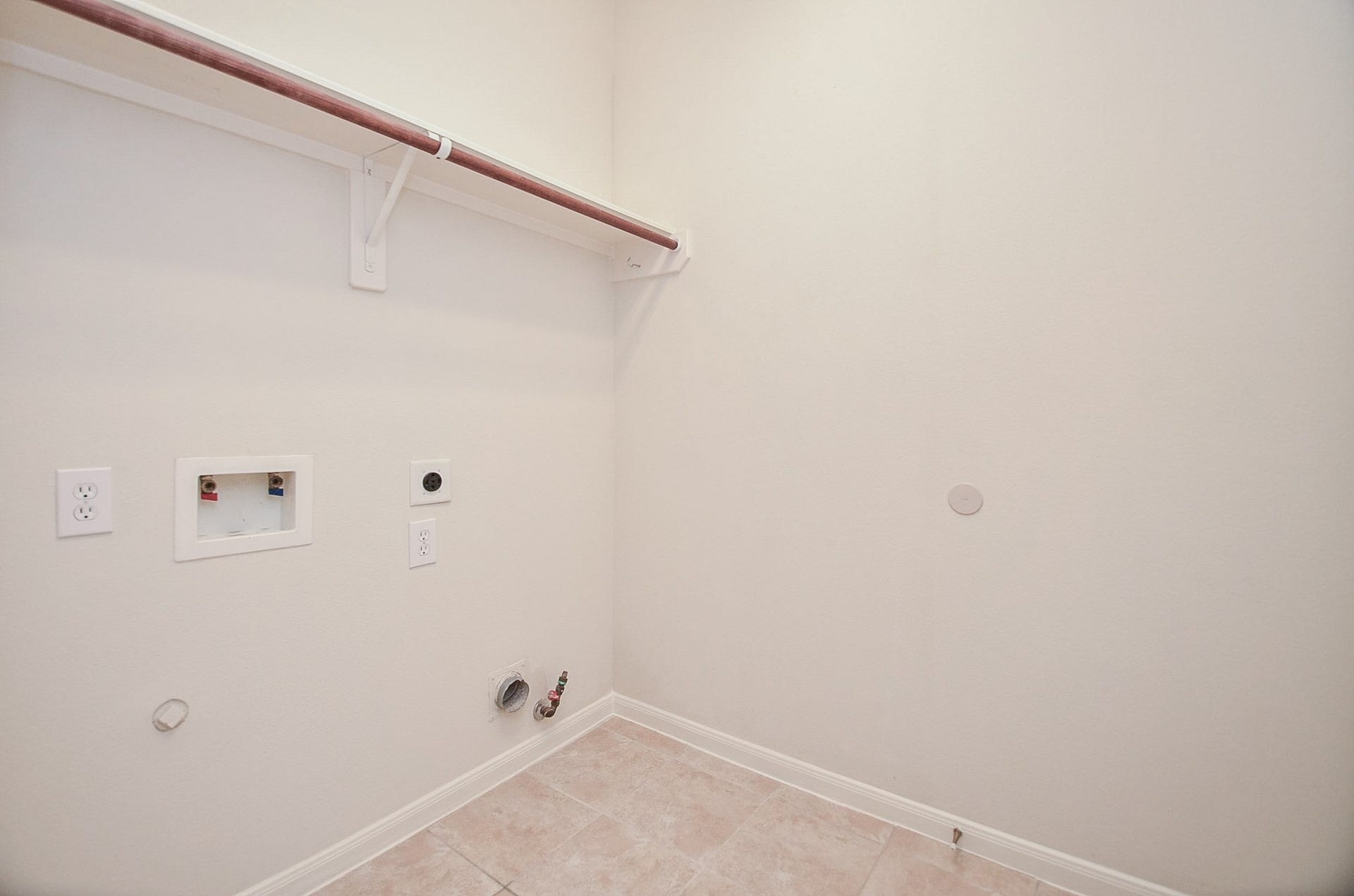 4746 Autumn Orchard Lane, Katy, TX 77494 Nestled among lush greenery, this charming brick home offers convenience with an efficient in-house laundry room, perfect for modern living.