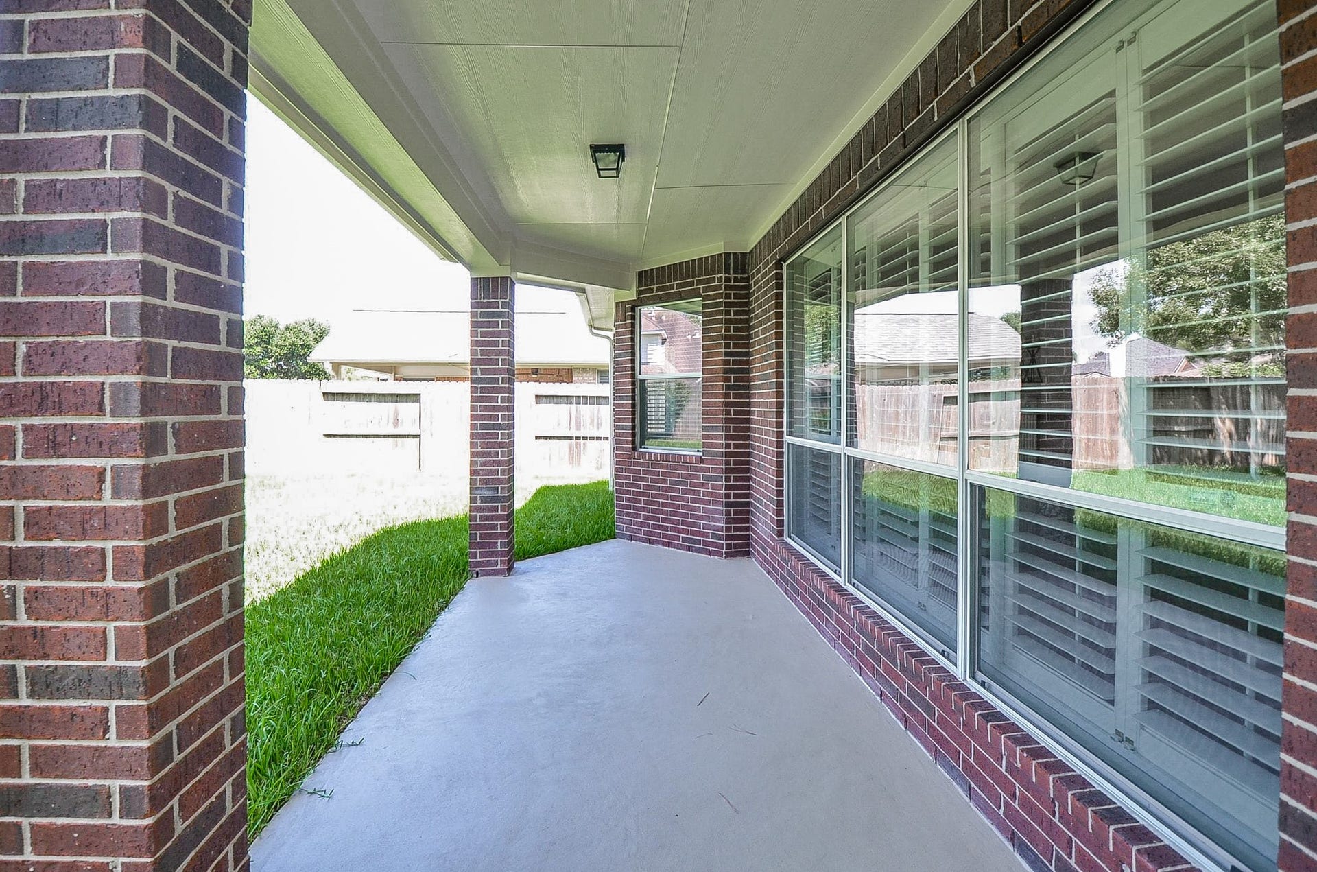 4746 Autumn Orchard Lane, Katy, TX 77494 Charming home in a tranquil neighborhood with a spacious covered patio, ideal for relaxation and entertaining amidst lush greenery.
