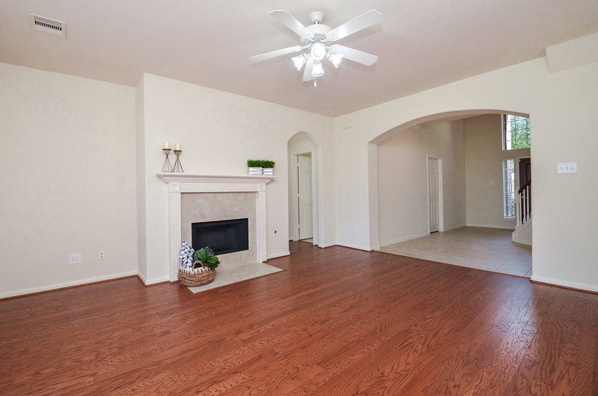 4746 Autumn Orchard Lane, Katy, TX 77494 Inviting family room with warm wood flooring and abundant natural light, ideal for creating memories.