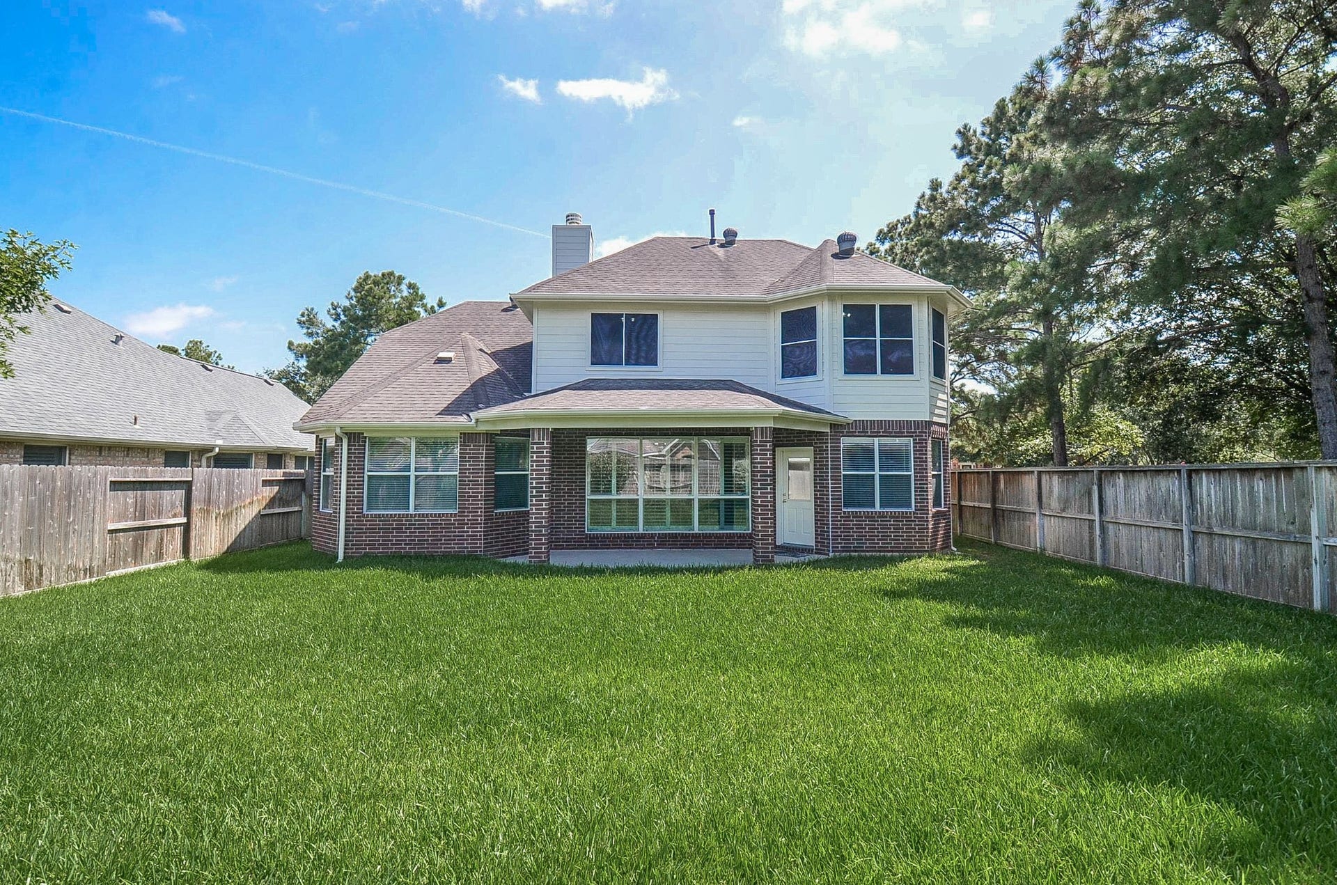 4746 Autumn Orchard Lane, Katy, TX 77494 Spacious home nestled on a large, lush lot with mature trees and a fenced backyard, offering ample privacy and outdoor space.