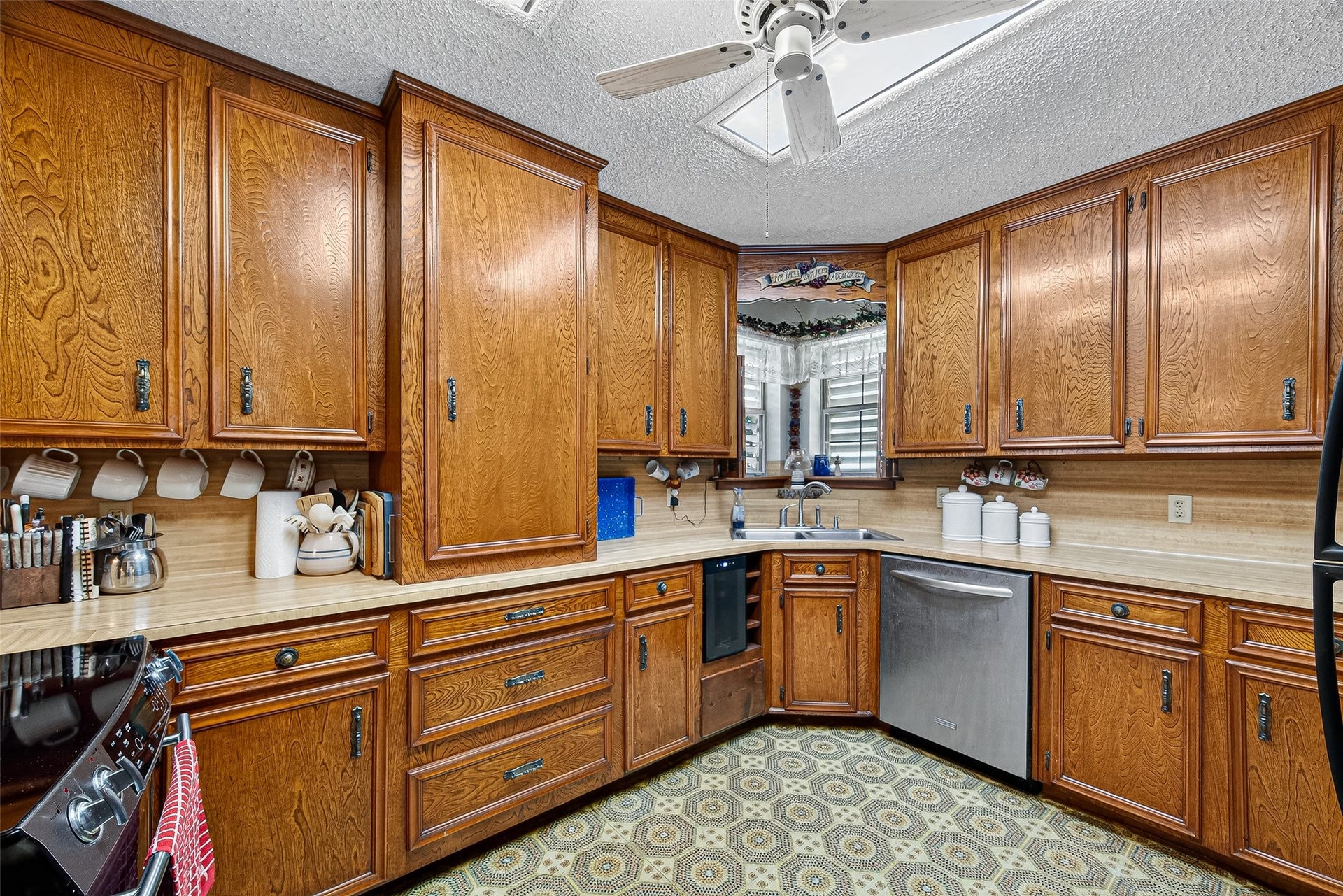 12021 7th 1/2 Street, Santa Fe, TX 77510 This kitchen features classic wooden cabinetry with ample storage, a stainless steel dishwasher, and a cozy corner sink. It has custom made cabinets and a rare large pantry cabinet in the interior of the kitchen making cooking an easy effort.