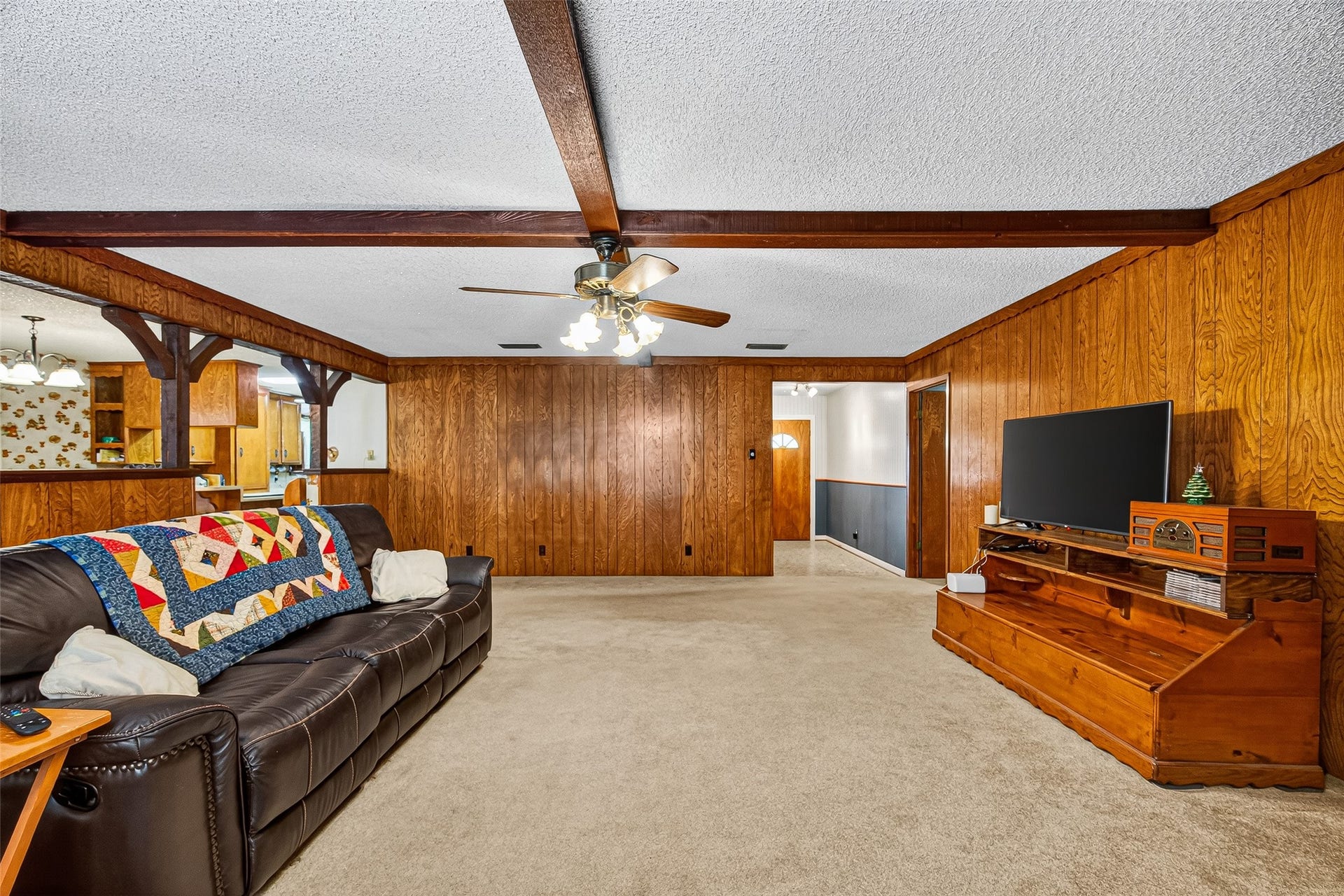 12021 7th 1/2 Street, Santa Fe, TX 77510 This cozy living room is open to the kitchen, providing a warm and inviting atmosphere, perfect for family gatherings.