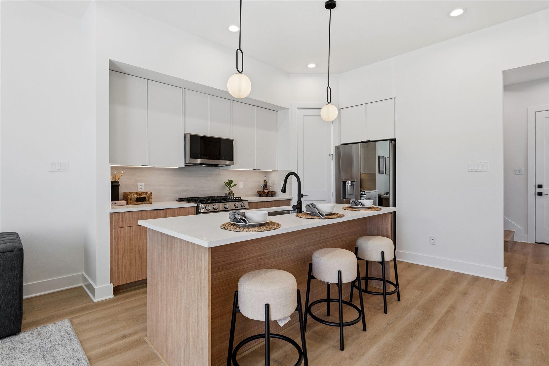 4610 Gunter Street, Houston, TX 77020 This space features two-tone cabinetry and a large stone-topped island. Minimalist pendants and integrated appliances highlight the clean, functional geometry.