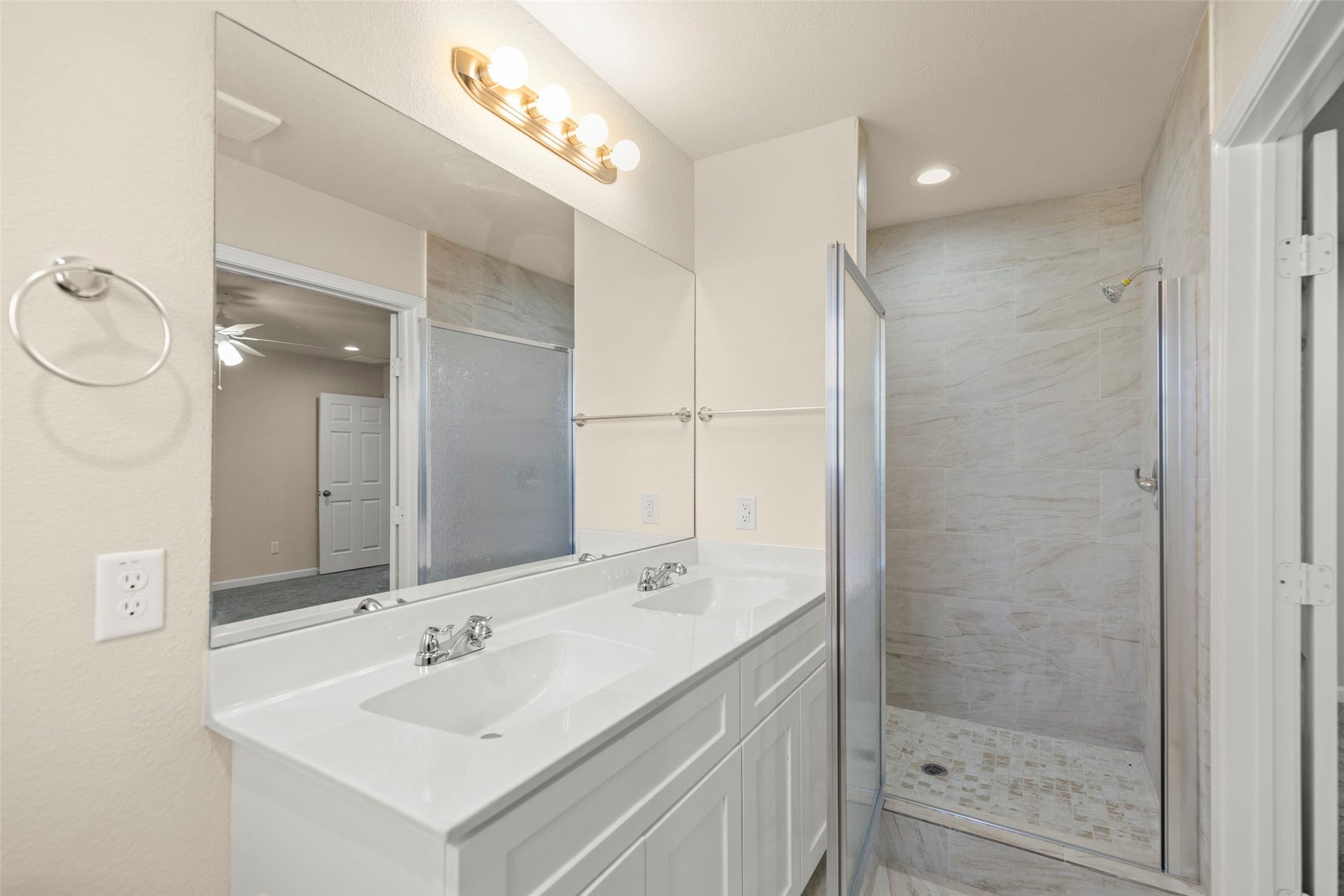 This photo shows a spacious walk-in closet with two levels of wooden hanging rods and shelves, featuring neutral-colored walls and carpet flooring. Ideal for organizing clothing and accessories.