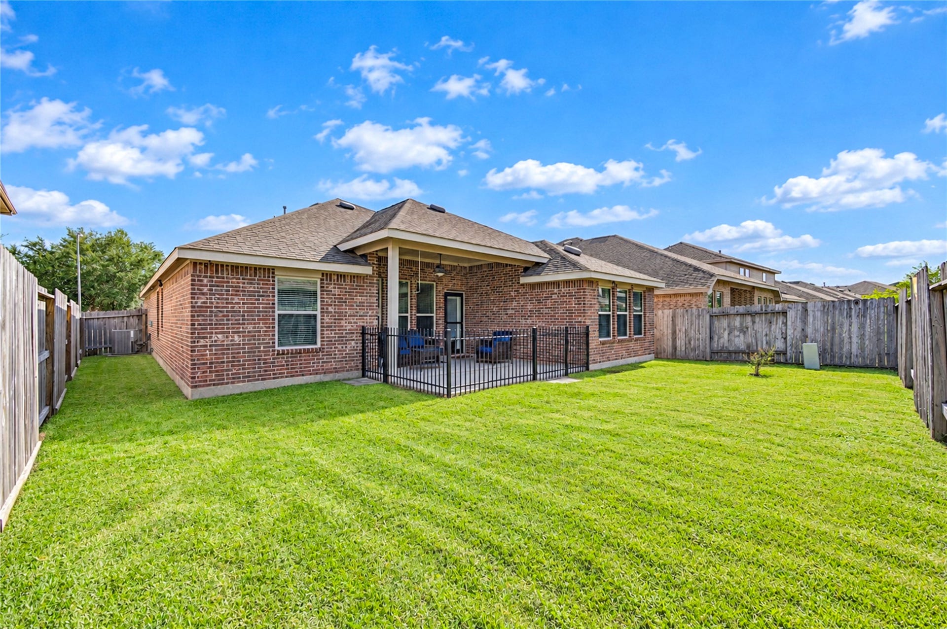 16719 Cactus Blossom Trail, Cypress, TX 77433 The back of the home looks over a fully fenced, level yard with plenty of room to play.