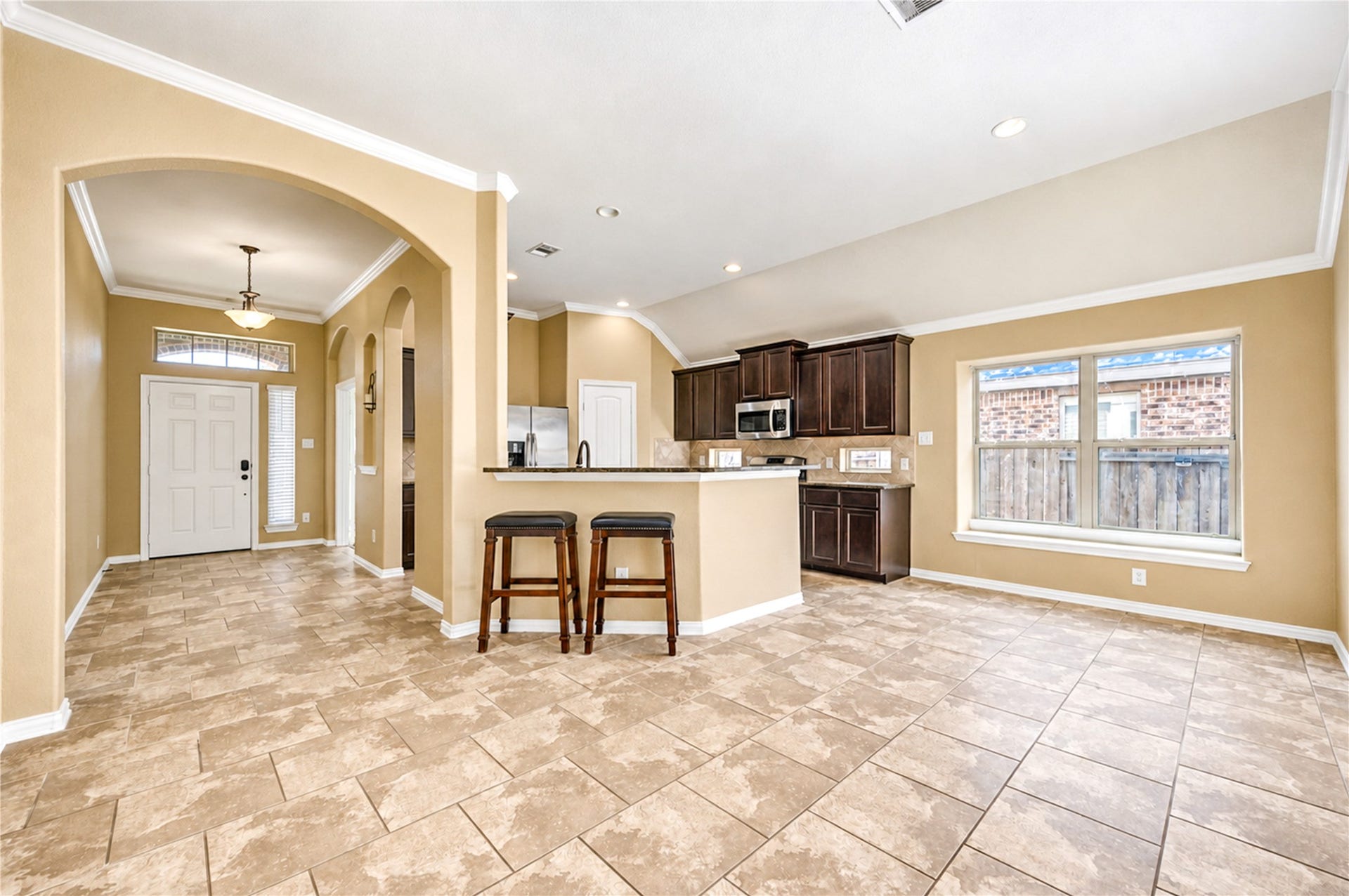 16719 Cactus Blossom Trail, Cypress, TX 77433 From the foyer, a graceful arch opens to the kitchen, where the breakfast bar anchors the shared living space.