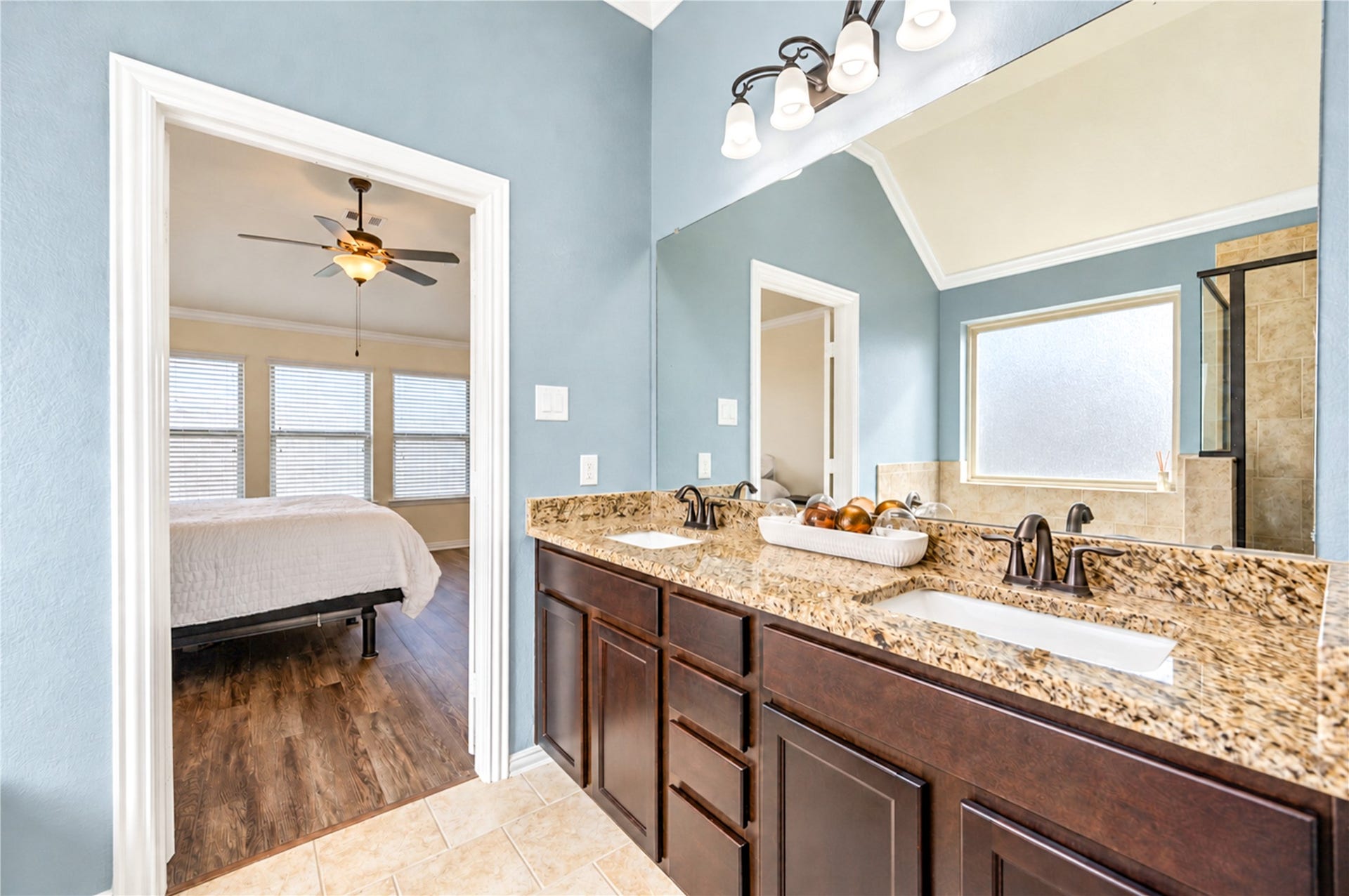 16719 Cactus Blossom Trail, Cypress, TX 77433 The primary bath's granite vanity with dual sinks opens directly to the bedroom.