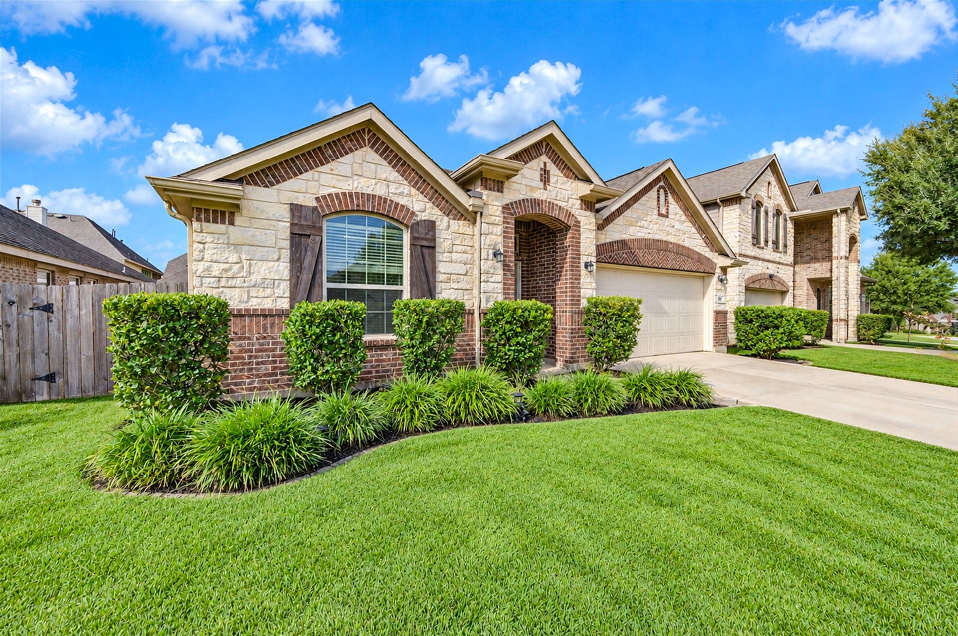 16719 Cactus Blossom Trail, Cypress, TX 77433 Stone, brick and shuttered windows give the faade a classic, well-balanced presence from the street.