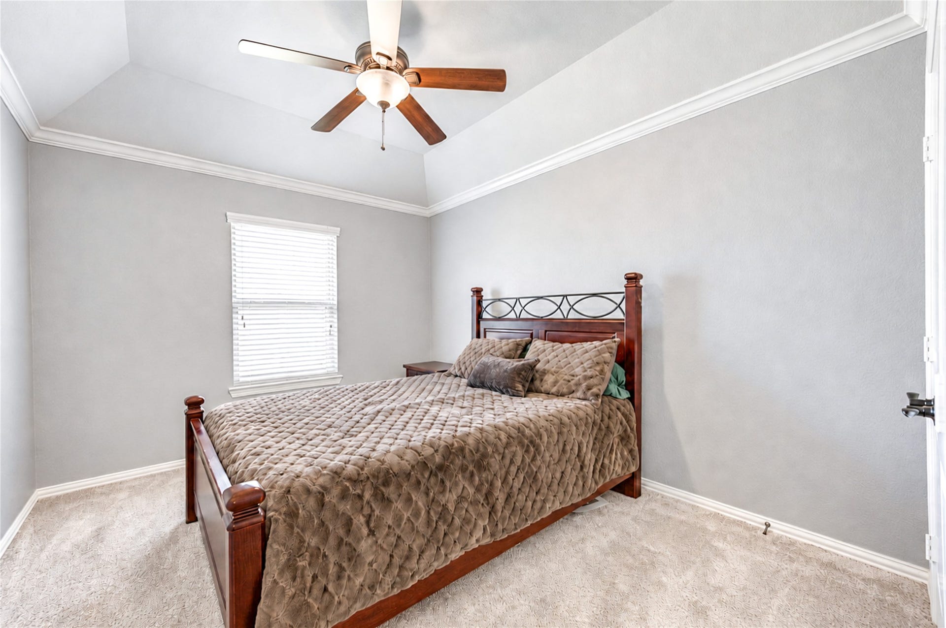 16719 Cactus Blossom Trail, Cypress, TX 77433 A secondary bedroom with a vaulted ceiling, ceiling fan and soft carpet.