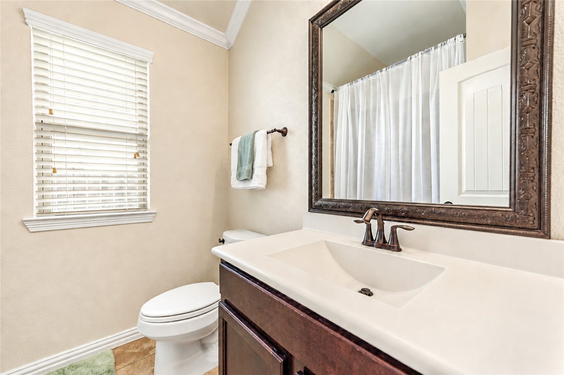 16719 Cactus Blossom Trail, Cypress, TX 77433 A cultured-marble vanity and a framed mirror complete the secondary bath.