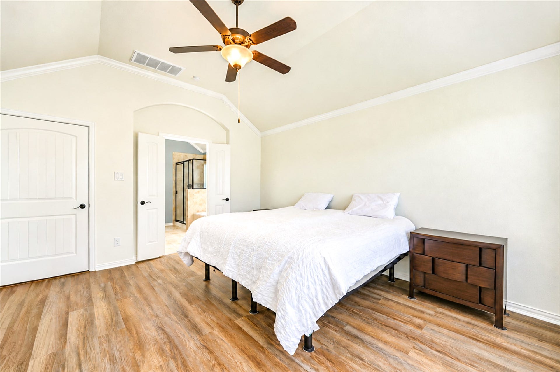 16719 Cactus Blossom Trail, Cypress, TX 77433 A tall ceiling and luxury vinyl plank flooring make the primary bedroom a calm retreat, with the bath entry nearby.