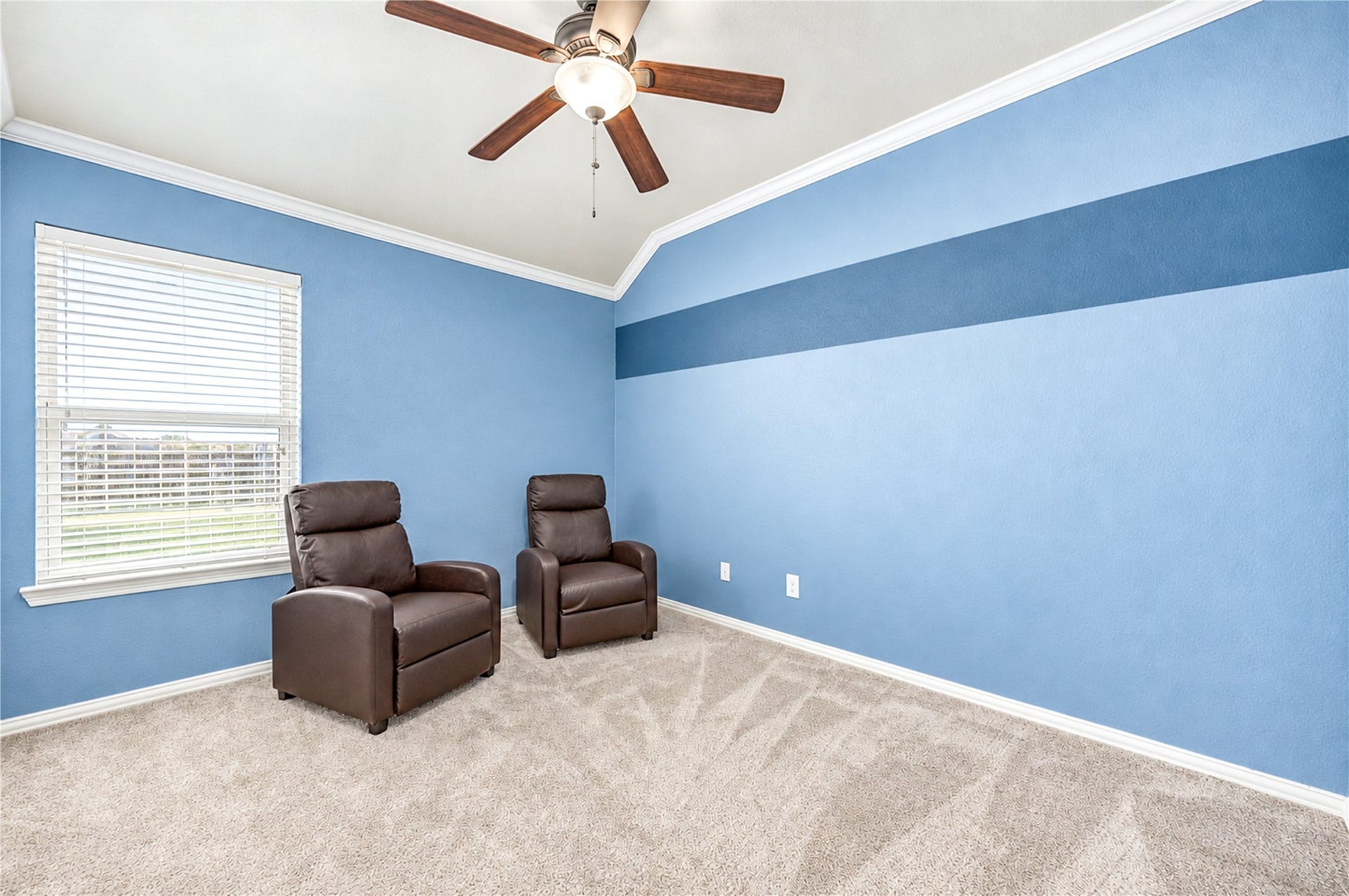 16719 Cactus Blossom Trail, Cypress, TX 77433 A bright corner bedroom with a ceiling fan, a large window and carpet.