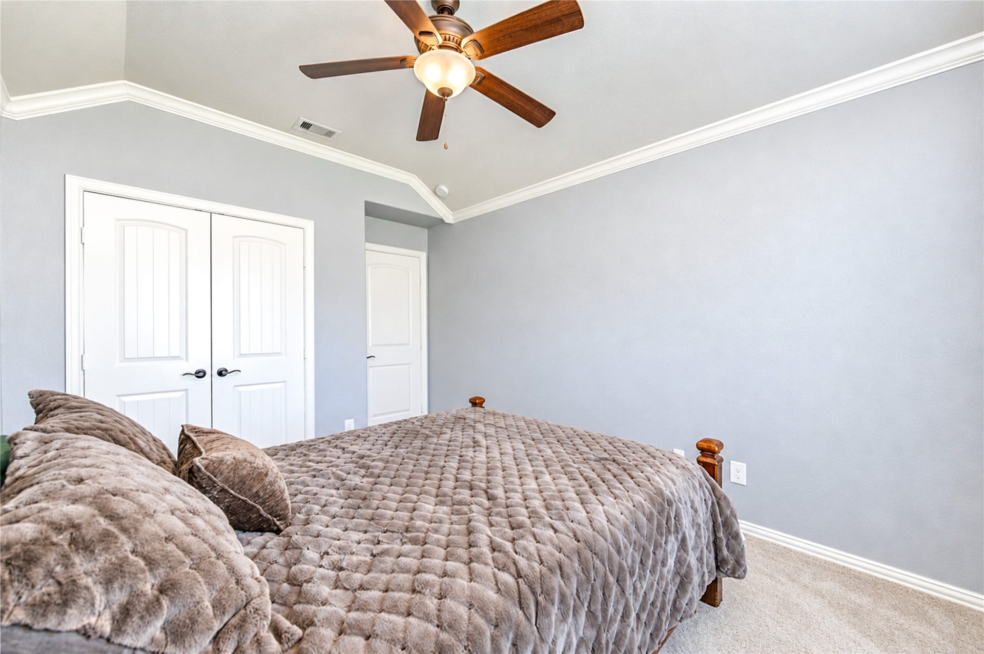 16719 Cactus Blossom Trail, Cypress, TX 77433 Double-door closets and a vaulted ceiling give this bedroom ample storage and height.