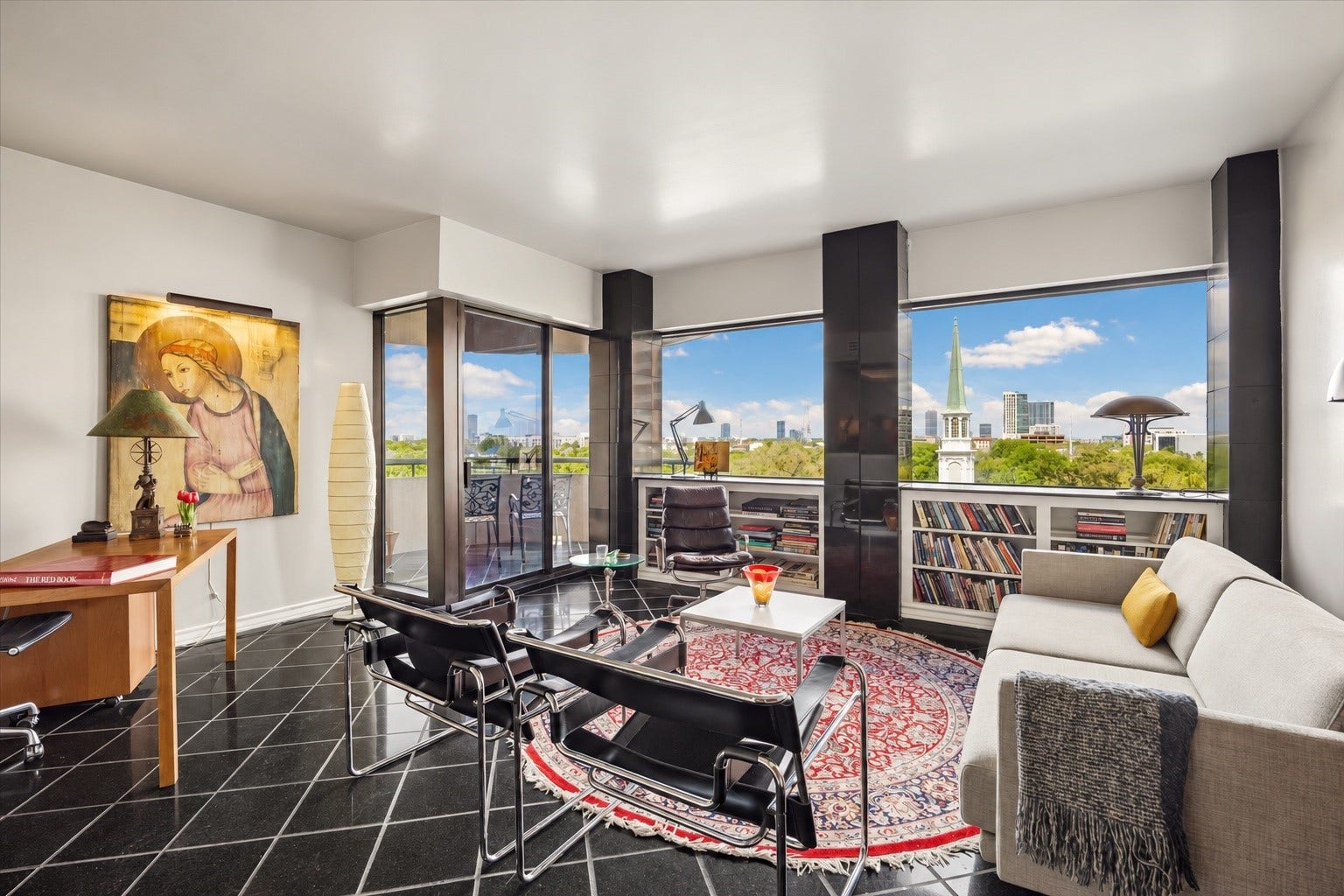 5000 Montrose Boulevard, #6A, Houston, TX 77006 The open living room features big windows, clean modern lines, and plenty of space for daily living or entertaining.