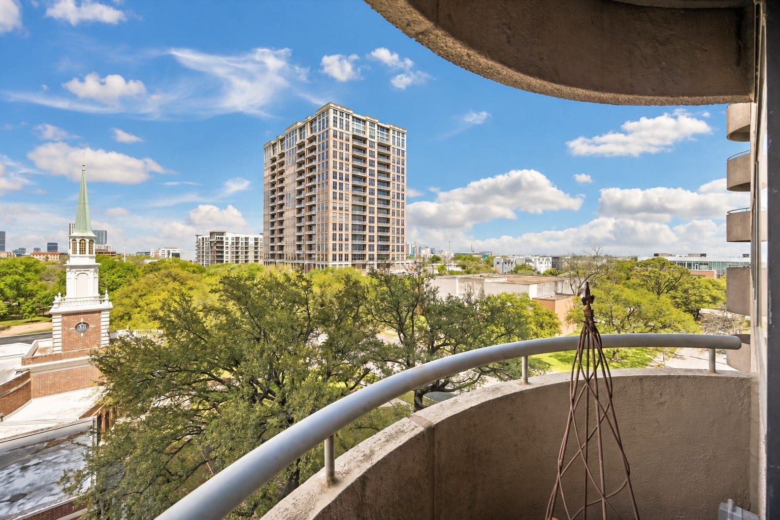 5000 Montrose Boulevard, #6A, Houston, TX 77006 The private curved balcony has granite tile and treetop and skyline views, adding outdoor living space.