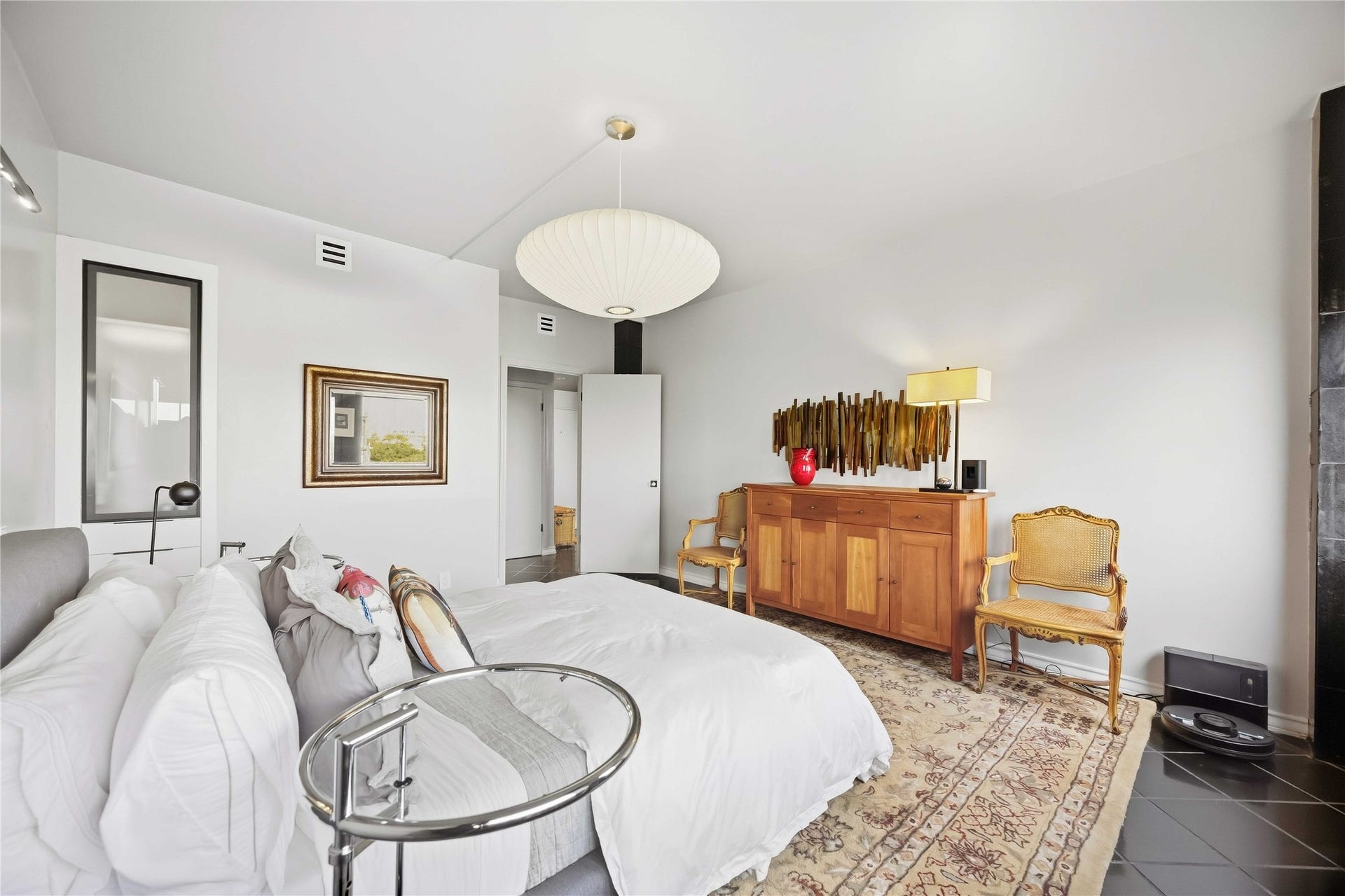 5000 Montrose Boulevard, #6A, Houston, TX 77006 Large windows frame treetop views and keep the primary bedroom bright and airy.