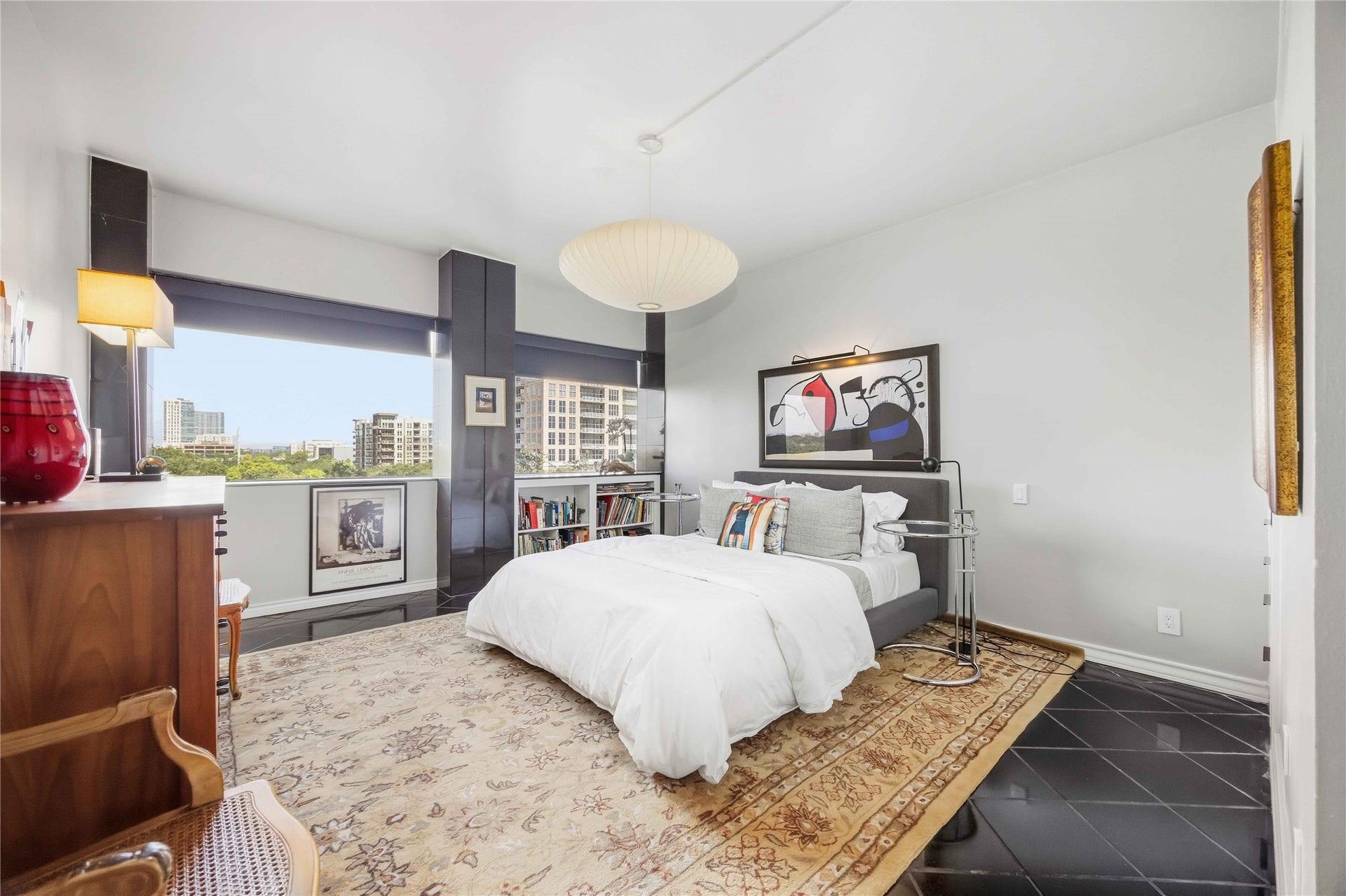 5000 Montrose Boulevard, #6A, Houston, TX 77006 The bedroom is a calm retreat with custom lighting, built-in storage, and large windows with neighborhood views.