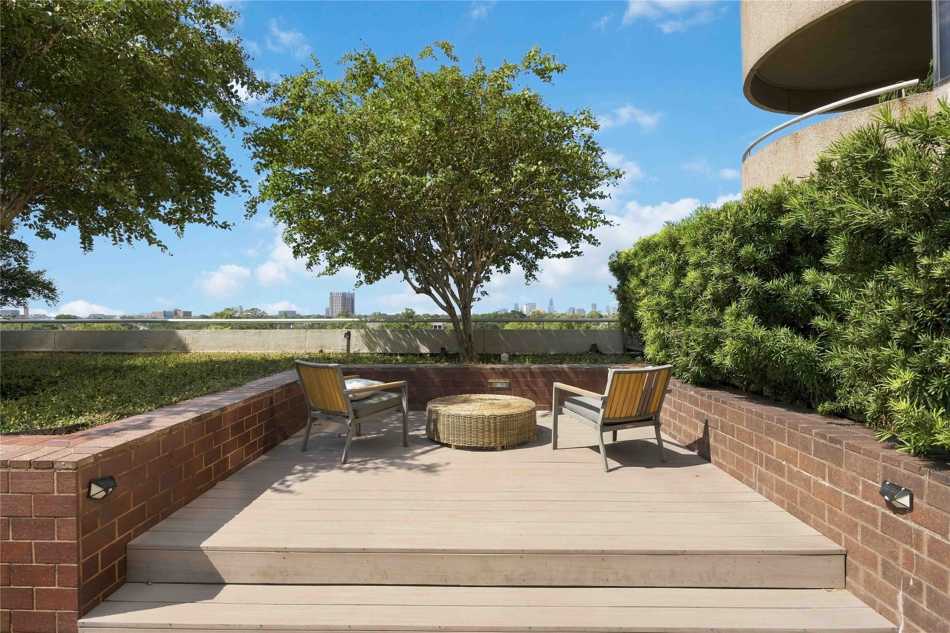 5000 Montrose Boulevard, #6A, Houston, TX 77006 An outdoor terrace surrounded by mature trees offers a quiet place to unwind.
