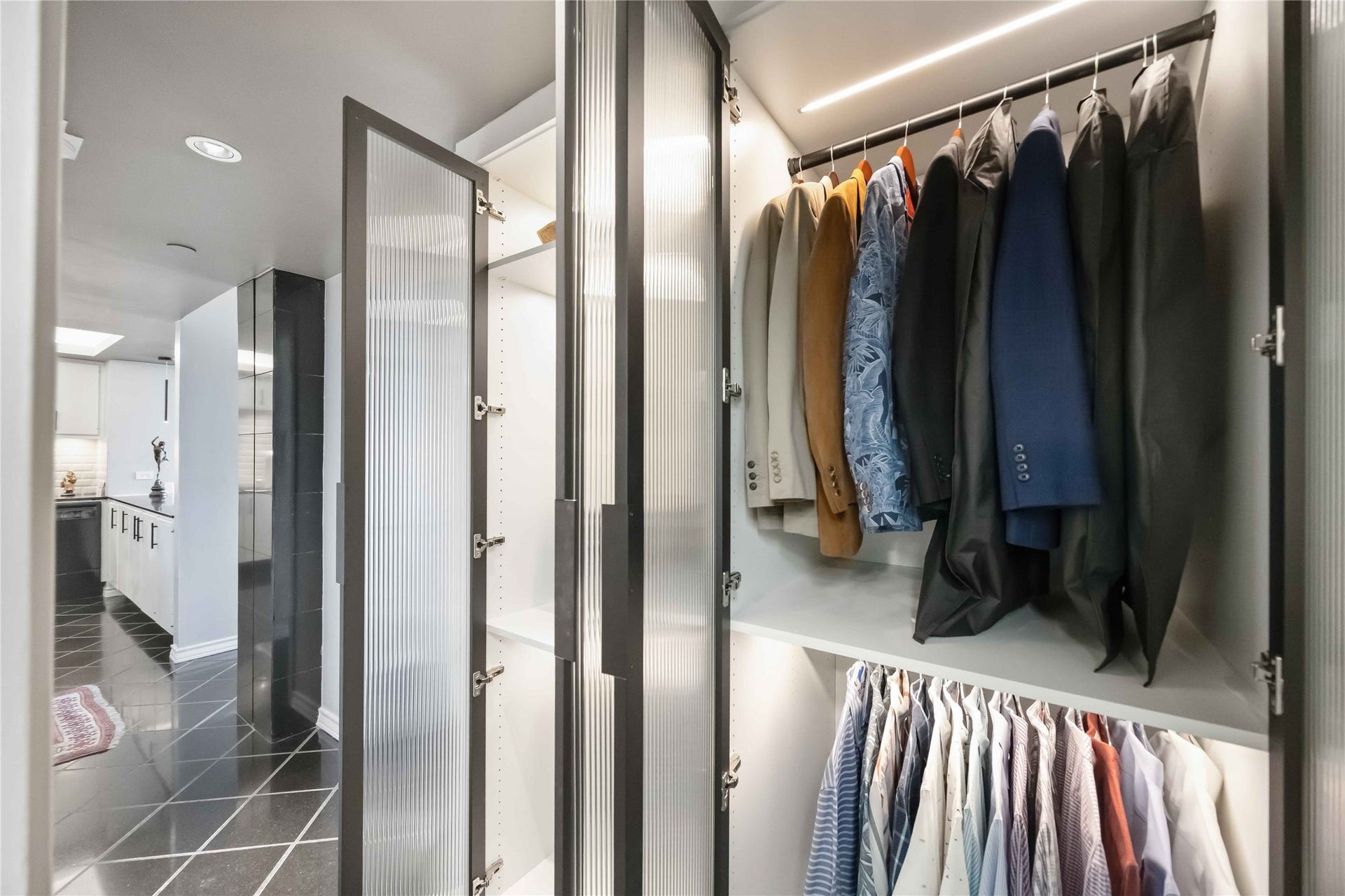 5000 Montrose Boulevard, #6A, Houston, TX 77006 A second custom closet offers lighted shelving and ample hanging space.