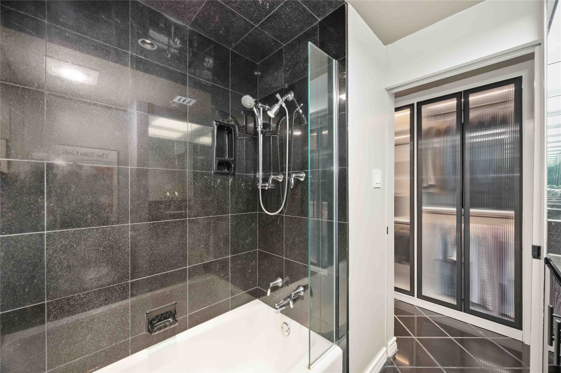 5000 Montrose Boulevard, #6A, Houston, TX 77006 A granite shower with custom lighting and sleek fixtures delivers a spa-like feel.