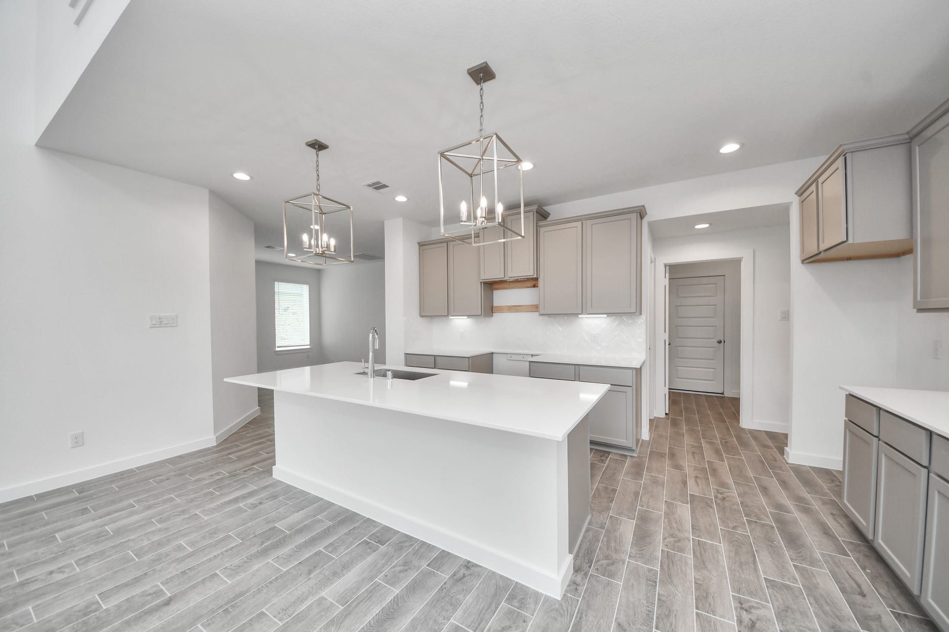 63 Knight Bayou Drive, Dayton, TX 77535 The open concept effortlessly connects the kitchen to the expansive family room, forming a perfect hub for gatherings. This seamless flow creates an inviting space where cooking and socializing come together harmoniously. Sample photo of completed home with similar floor plan. Actual colors and selections may vary.