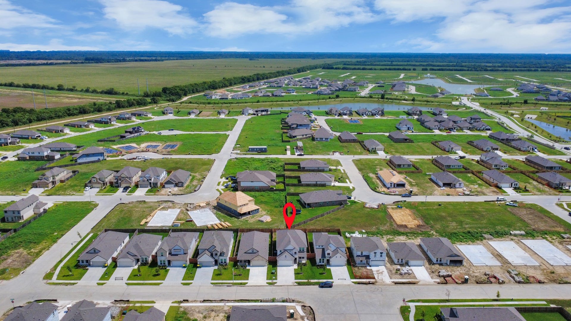 63 Knight Bayou Drive, Dayton, TX 77535 An aerial view of a spacious subdivision lot, highlighting a well-maintained yard and a fully fenced perimeter, offering both privacy and expansive outdoor space.