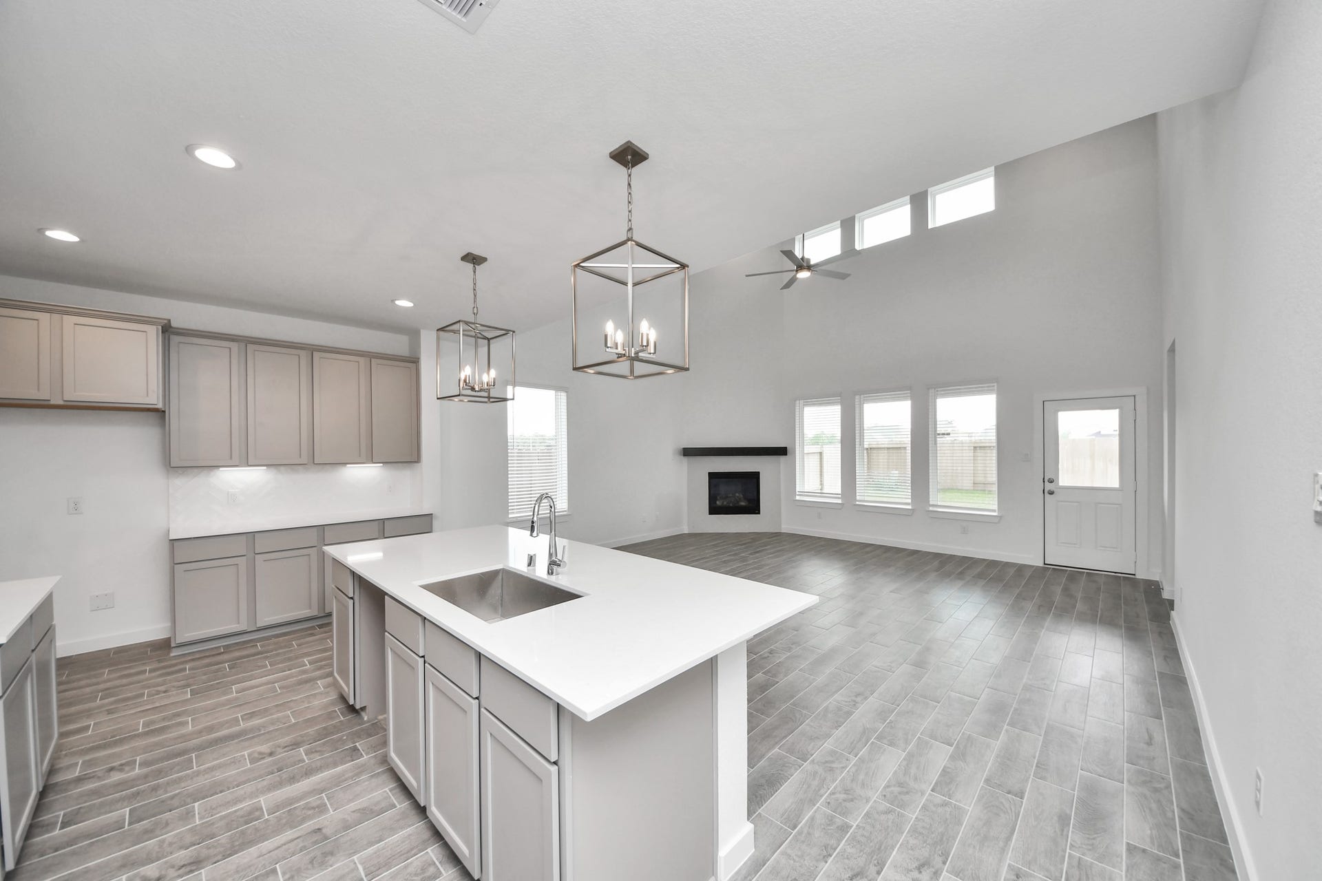 63 Knight Bayou Drive, Dayton, TX 77535 Step into a dream realized with this generously spacious kitchen! A massive granite island takes center stage, complemented by high ceilings and soft-close cabinets. The granite countertops, stainless steel appliances, sleek tile backsplash, and recessed lighting complete the elegant design. Sample photo of completed home with similar floor plan. Actual colors and selections may vary.