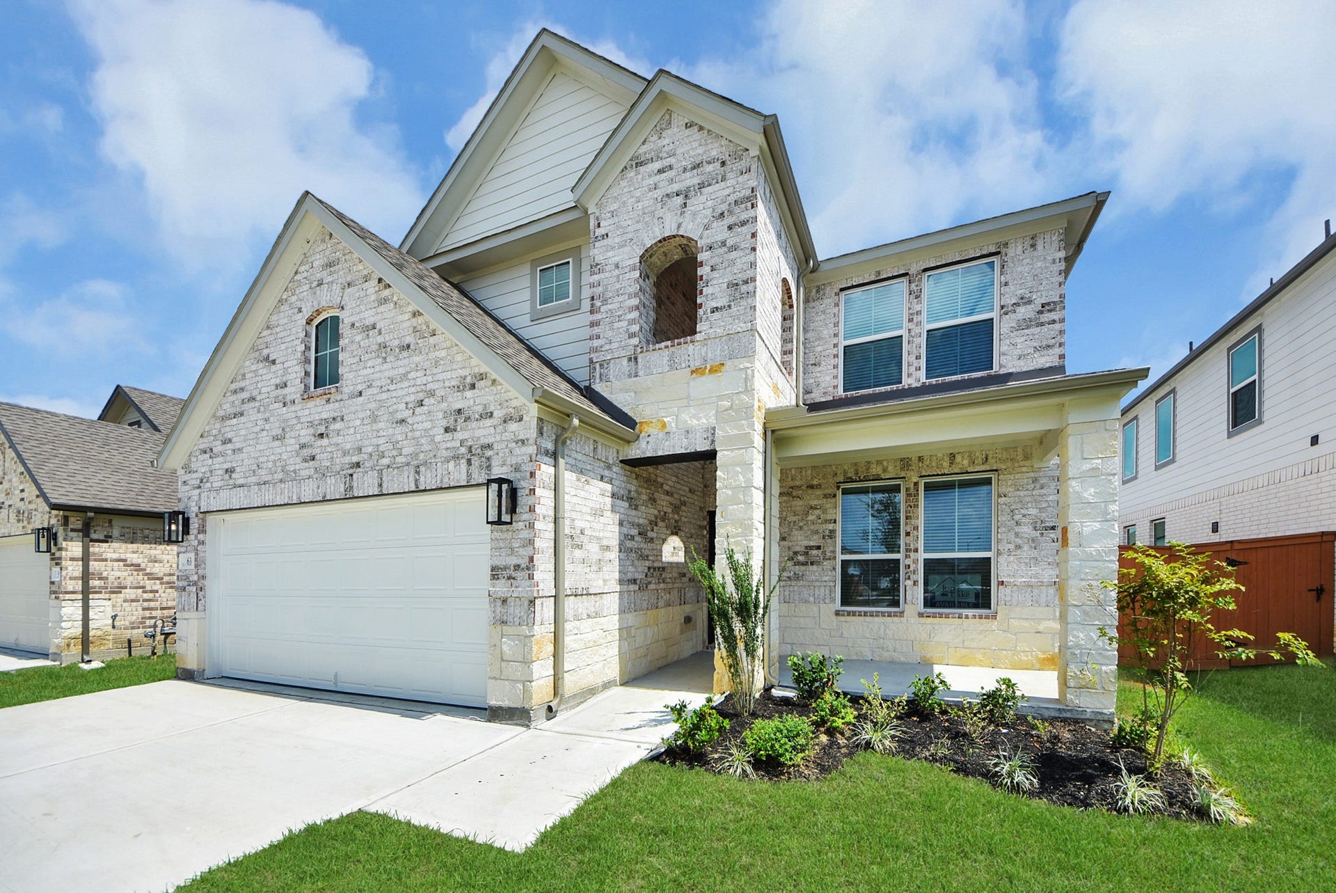63 Knight Bayou Drive, Dayton, TX 77535 The residence features a practical 2-car garage complemented by a generous driveway, ensuring abundant space for parking needs.