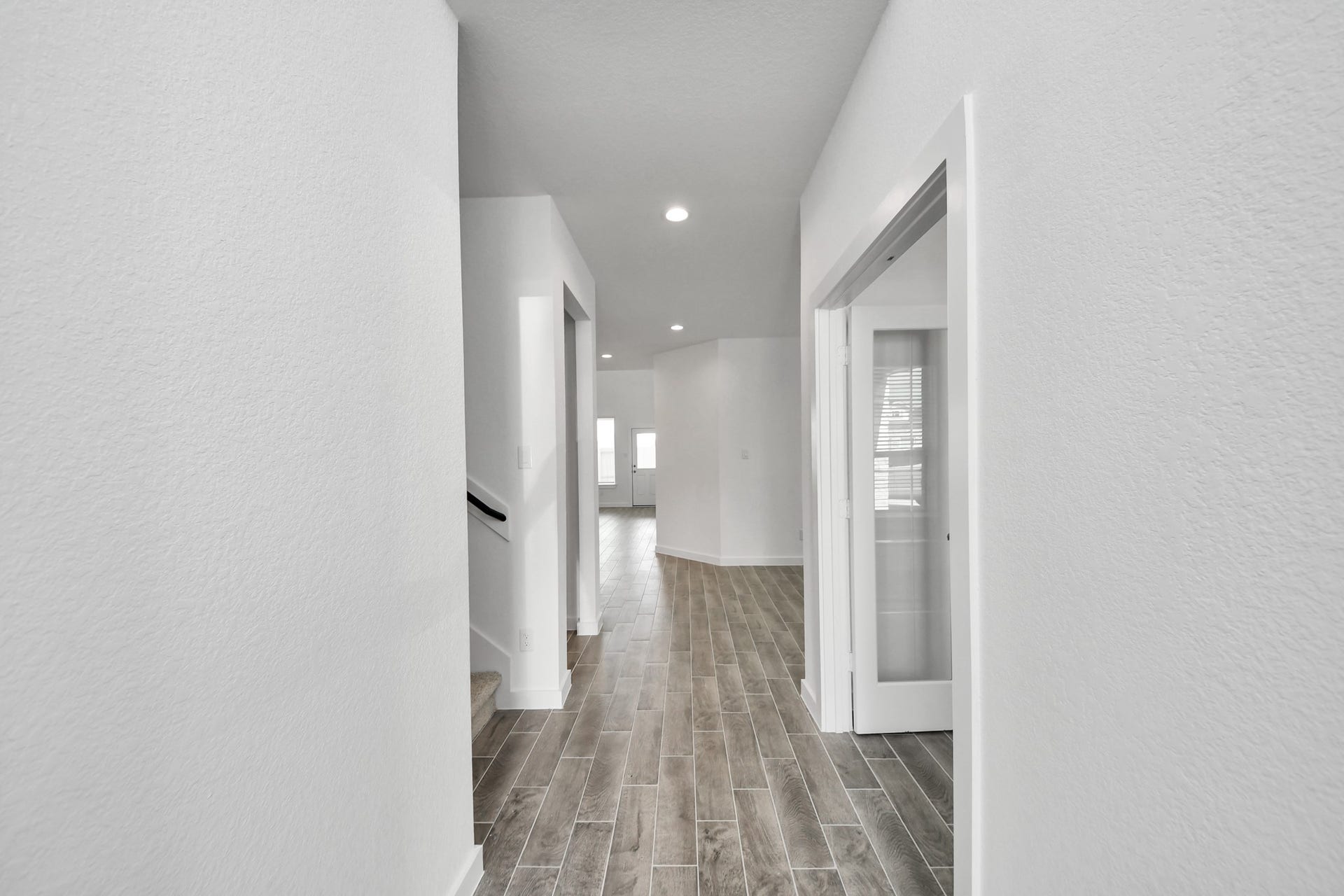 63 Knight Bayou Drive, Dayton, TX 77535 As you step into the threshold of this luxurious home, you'll soon be welcomed by an elegant glass door (to be installed). Inside, soaring ceilings amplify the spaciousness, while the refined wood-look tile flooring and oversized baseboards exude sophistication and charm. Sample photo of completed home with similar floor plan. Actual colors and selections may vary.