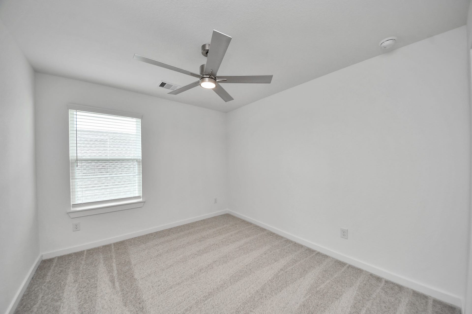 63 Knight Bayou Drive, Dayton, TX 77535 Secondary bedroom features plush carpeting, large windows that let in plenty of natural light, bright paint, and spacious closets. Sample photo of completed home with similar floor plan. Actual colors and selections may vary.