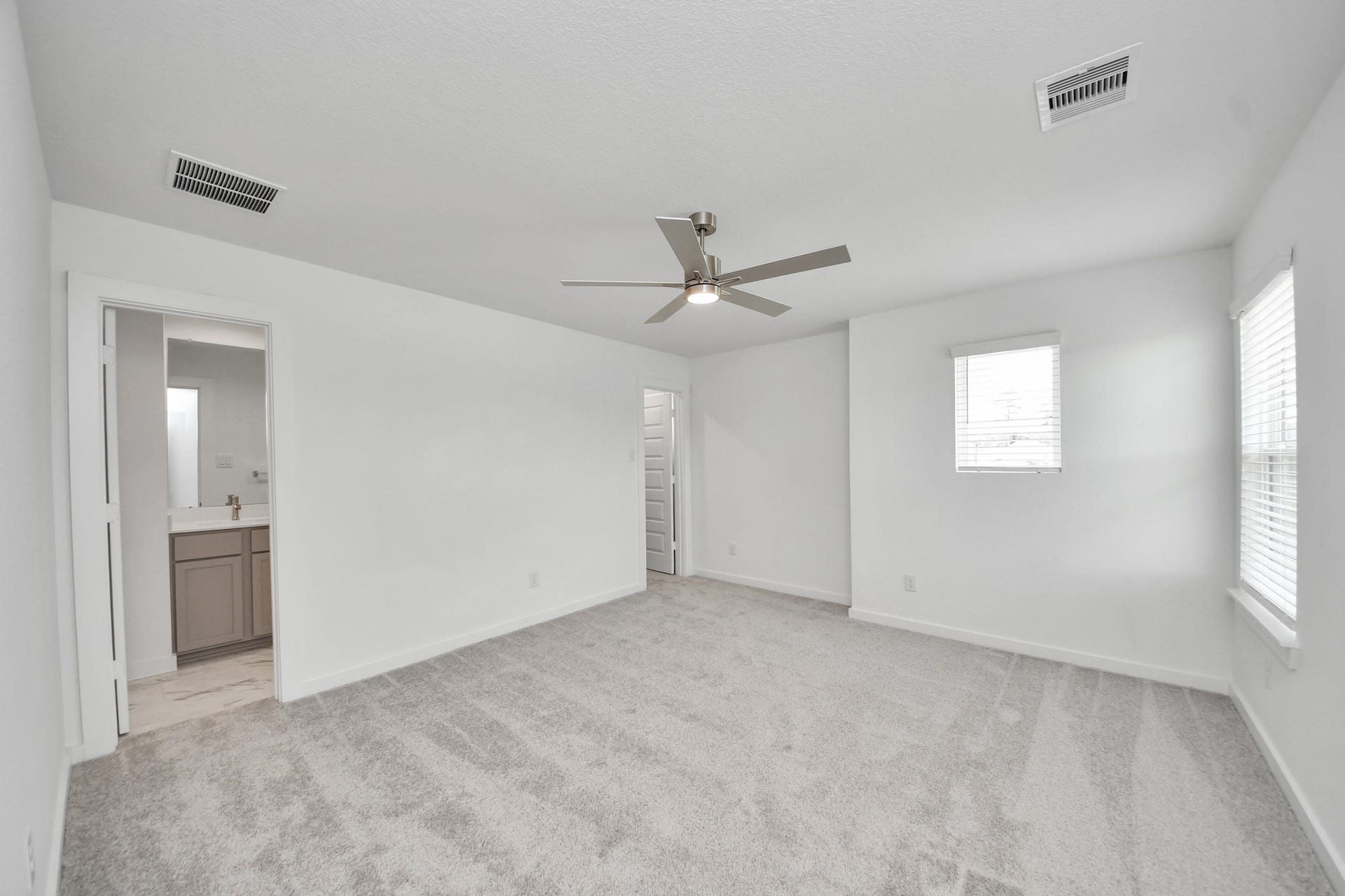 63 Knight Bayou Drive, Dayton, TX 77535 Secondary bedroom features plush carpeting, large windows that let in plenty of natural light, bright paint, and spacious closets. Sample photo of completed home with similar floor plan. Actual colors and selections may vary.
