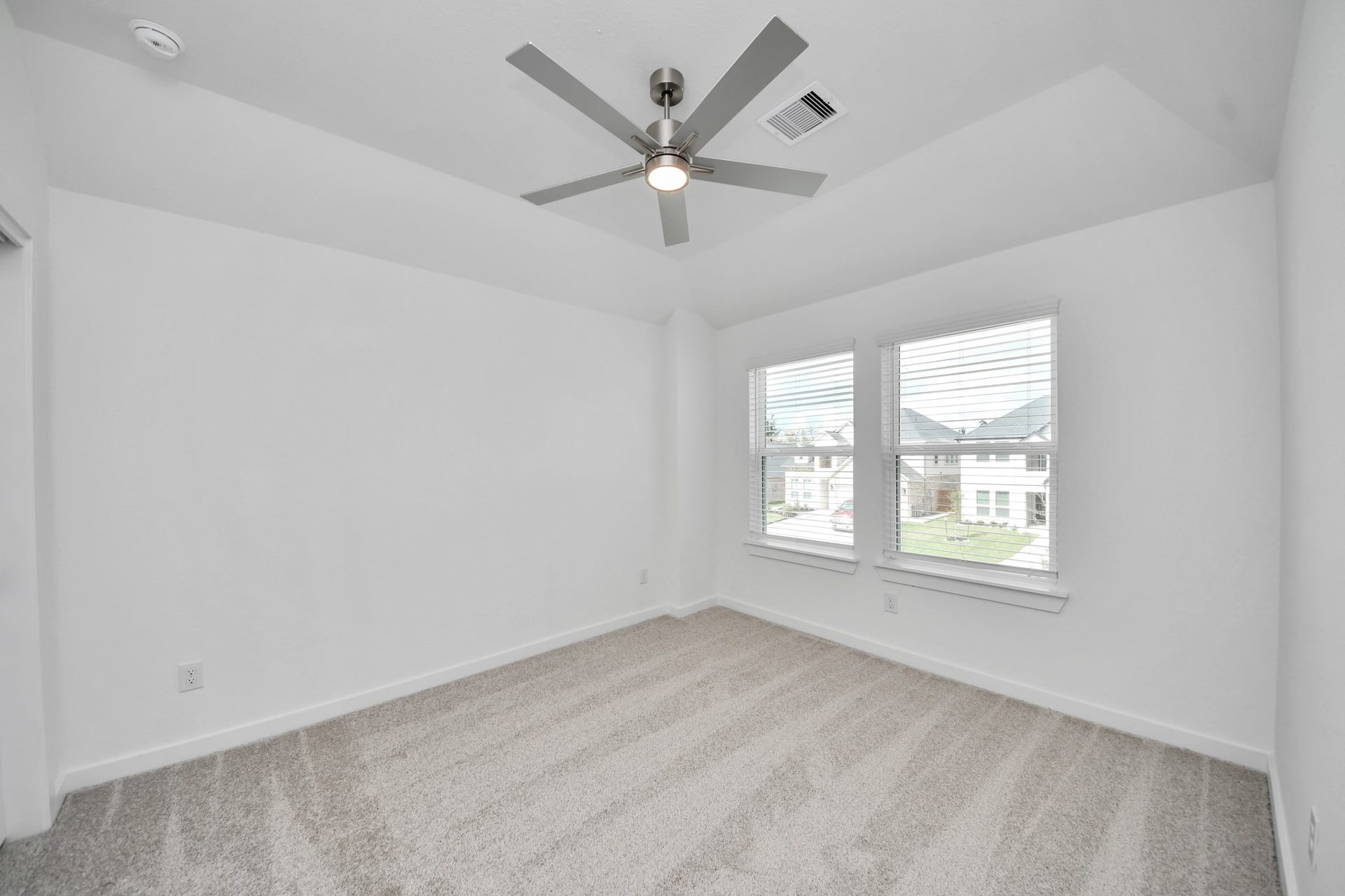 63 Knight Bayou Drive, Dayton, TX 77535 Secondary bedroom features plush carpeting, large windows that let in plenty of natural light, bright paint, and spacious closets. Sample photo of completed home with similar floor plan. Actual colors and selections may vary.