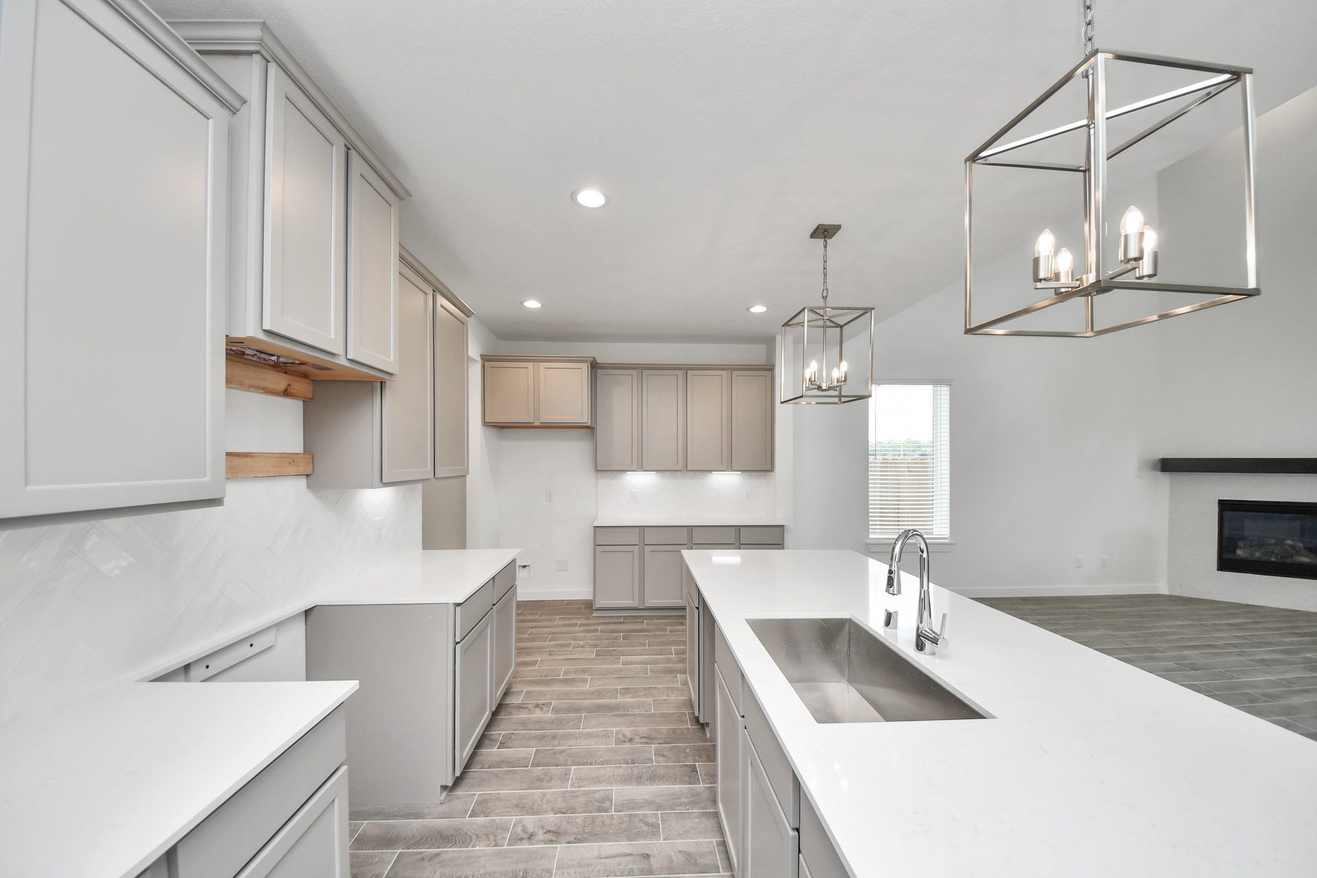 63 Knight Bayou Drive, Dayton, TX 77535 The kitchen is a culinary haven, featuring granite countertops, a tile backsplash, stainless steel appliances, 42 upper cabinets, and undercabinet lighting. Sample photo of completed home with similar floor plan. Actual colors and selections may vary.